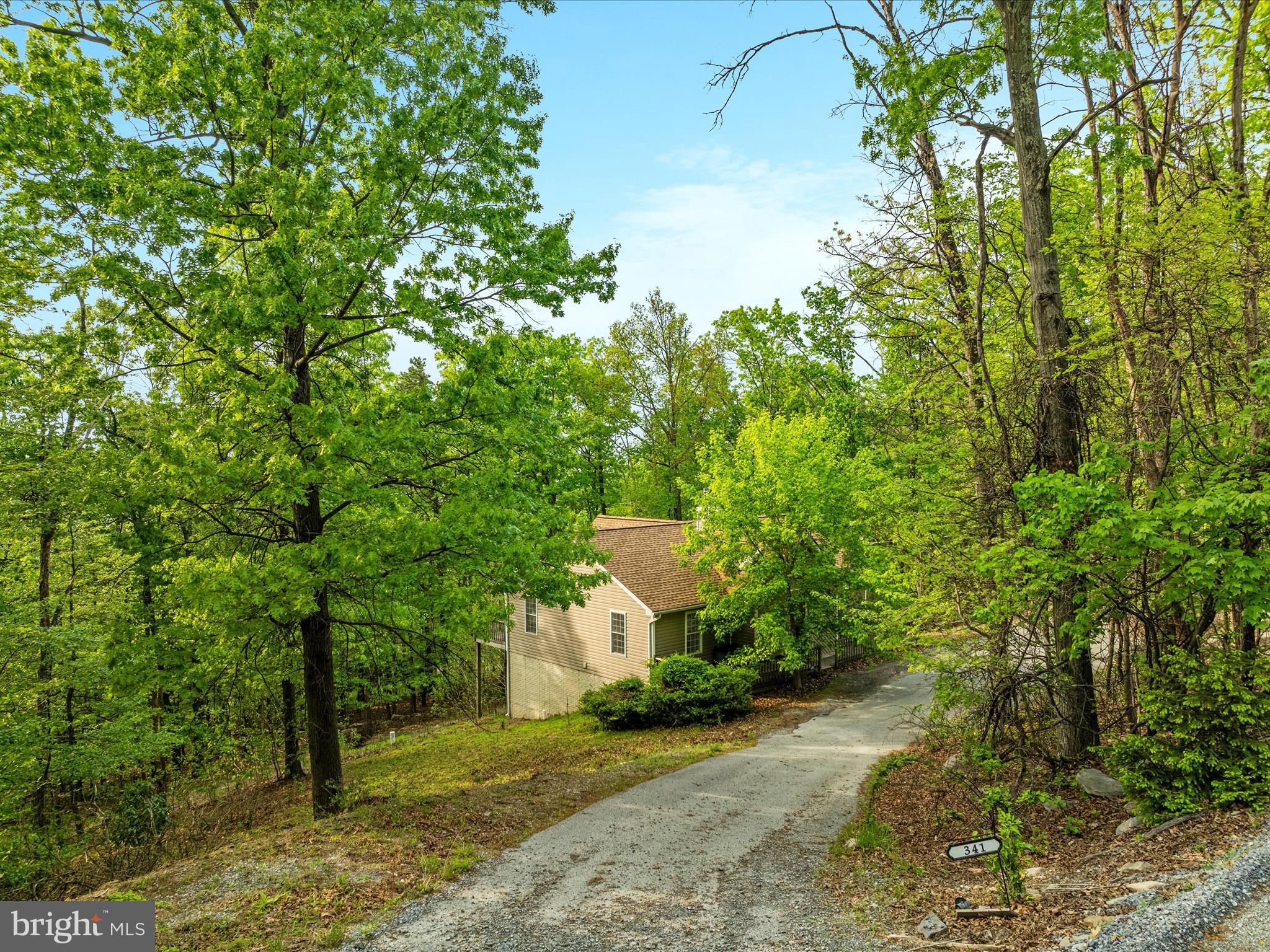High atop the western slope of the Blue Ridge Mountains, and nestled between the Appalachian Trail and the Shenandoah River is the community of Shannondale. And here, at one of the highest perches of this beautiful spot is 341 Wren Ln. In the wintertime when the trees are bare, the views are, well, “top of the world”. <br><br>
Step inside the open floor plan with vaulted, beamed ceilings and skylights, and an enormous stone woodburning fireplace grounds the space. From there, the floorplan just works. You’ll see. <br><br>
This 2000sf home with 3 bedrooms and 3 full baths has many new touches – the entire main level has new paint and flooring (LVP and carpet) and the kitchen features brand new quartz countertops, sink, faucet and disposal.  There is a deck that spans the entire back of the home, where peace and quiet are found 24/7.<br><br>
The lower level has 800 finished square feet, perfect for a rec room, office, exercise area, or even to have a guest space. The full bath in the lower level makes it practical and functional for all of your ideas.<br><br>
No HOA, no “next door neighbors” except the wildlife. <br><br>
This may be your weekend escape from NOVA/DC, or your forever home. It’s spacious enough and designed to work easily either way. So come check it out and fall in love.