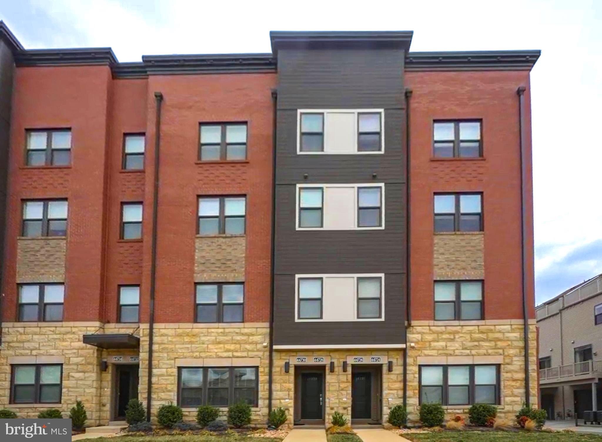 Amazing location! Welcome into this beautifully maintained 2 level townhome style condo located in the center of One Loudoun! Enter on the main level from the front door into the open concept living and dining area with LVP flooring (installed 2021) throughout. Gourmet kitchen boasts stainless steel appliances including a cooktop, double wall ovens and gorgeous granite countertops. New dishwasher, 2025 and seperate pantry closet. A spacious island with room for plenty of seating and dark wood cabinets make for the perfect entertaining space.  A convenient door leads to the rear entry, one car garage, and a driveway large enough for another vehicle. A half bathroom completes this floor. The next flight up contains a spacious light filled primary bedroom with two large walk in closets, an en suite bathroom with double sinks and a glass enclosed shower. Additionally, the second bedroom on this level has a long covered balcony, perfect for relaxing at the end of a busy day. There is a third bedroom, and a full bathroom as well. Lastly, on this floor are a full sized washer and dryer, helping make laundry a breeze! Located directly across from One Loudoun, walk to Trader Joe’s, Top Golf, movie theater, coffee shops, restaurants, shopping, and more! The outstanding neighborhood amenities include community pools, club house, playground, tennis and basketball courts, trails, etc. Easy access to the Dulles Toll Rd, Rte 7 and 28 and Dulles Airport. This one is a must see!