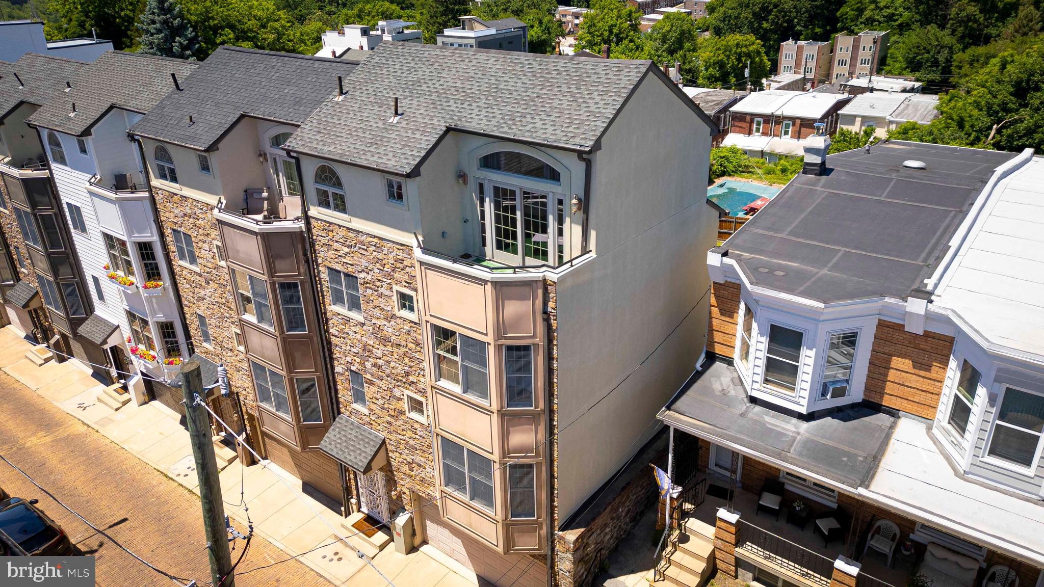 Welcome home to 308 Dupont St a beautifully maintained home in the vibrant Manayunk/Roxborough neighborhood. This expansive home offers 3 spacious bedrooms, 2.5 bathrooms, 2 car garage and multiple balconies. The home is illuminated with natural light and hardwood flooring throughout. The first floor gives you a warm welcome to the house. You have inside access to your extra large 2 car garage and bonus outdoor space as well as some extra storage space. On the main floor you will find an open floor plan with 9 ft+ high ceilings and  an abundance of natural light. The gourmet kitchen features classic white cabinets, a large island and stainless steel appliances. The main floor is rounded out with a half bathroom and the first of two balconies. On the third floor you will find two large bedrooms with ample closet space, your first full bathroom, laundry and additional storage. The top floor is dedicated to a spacious primary suite with a private balcony, walk-in closet, and a spa-inspired bathroom with recent upgrades. Additional highlights include multi zone heating and A/C, new water heater (2025), new refrigerator, and refinished balconies (2022). Easy access into downtown Philly, University City and suburbs. Walkable to Main Street Manayunk shops, bars, cafes, restaurants and amenities in Northwest Philadelphia. Everything is at your fingertips from 308 Dupont's prime location.
