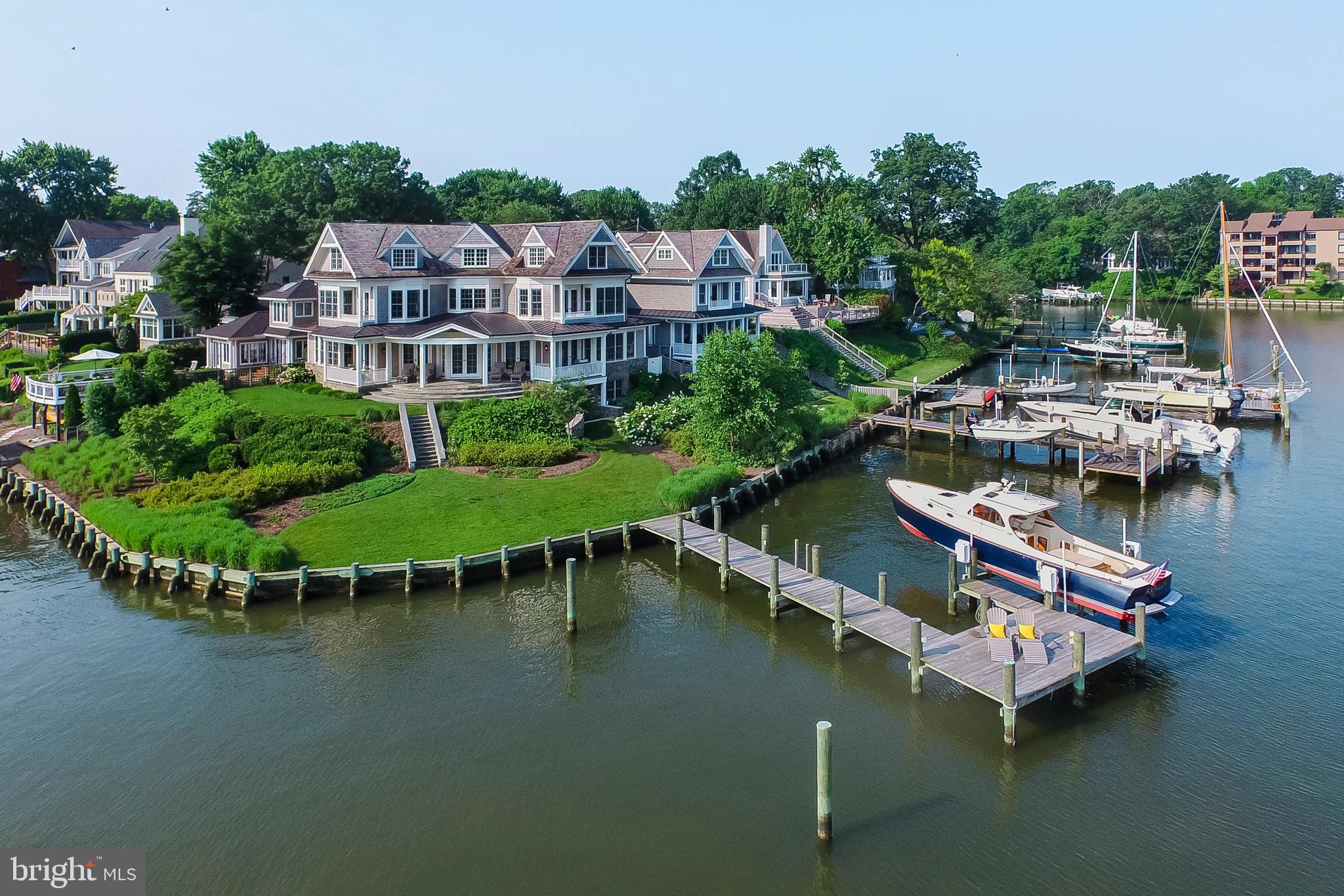 A premier Eastport waterfront location boasting dramatic & expansive water views of  Spa Creek and the magnificent skyline of historic Annapolis. Beautifully designed and built with the finest materials, this residence offers an open floor plan maximizing  water views from its elevated setting.  The 220 feet of water frontage  includes a private, protected, deep water pier  with dockage for a 60 foot boat and  an additional slip with a  20,000 pound boat lift.  Four levels of comfortable living spaces, water views from almost every room, incredible bluestone covered porches, 4 bedrooms, 4 1/2 baths and elevator ready.  Light filled great room with ebony stained oak floors, wood burning  fireplace and cofferred ceilings. Professionally designed kitchen with concrete island, open shelving & large pantry. Master suite with private balcony over looking the water and a view to the Capital Dome,  a spacious bath with marble countertops and a walk-in closet. The guest suite offers waterview's to the Annapolis Yacht Club and a private bath with soaking tub.  The top floor features a bunk room for 6, a fourth  bedroom and bath plus a common sitting area. Walk out to the pier from the finished  Lower level with its spacious entertaining room, exercise room, full bath and potential for theatre room. 1-car garage. Truly an ideal setting  watching the Blue Angels, 4th of July fireworks and the Parade of Lights. Walk to town location. Absolutely the best  Annapolis has to offer!