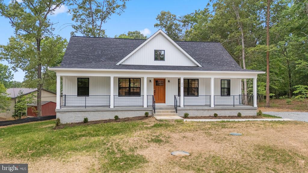 Quietly nestled within the Lake Anna-access community of Edgewood Bay, this just- completed custom home includes open living spaces aplenty and a setting that places the lake’s shoreline within a stone’s throw. Introducing 224 Edgewood Drive from Ironwood Homes! Reflecting the builder’s new Willow floor plan, this 4-bedroom, four-bath Traditional style residence sits on a nearly one-acre parcel framed by mature trees, offering both privacy and wiggle room. There is an additional bonus room in the basement that is currently being used as a designated bedroom as well. It’s less than 750 feet from multiple shores of the lake, folks! Tucked on a level 0.92-acre homesite, the home was designed with comfort in mind, with the majority of its square footage on the open main level, with additional living quarters upstairs and a fully finished lower level. The home encompasses more than 2,991 finished square feet, including two suite-style bedrooms that provide flexibility for guests and extended family. Edgewood Bay residents enjoy lake access, an annual HOA fee of approximately $200 + and additional $200 for the boat slip that is an included deeded amenity available with the property! Outside, clean white siding and cast-iron porch railings create a crisp first impression with subtle modern touches. The expansive, deep, concrete front porch spans nearly 50 feet wide and offers ample room for rocking chairs or porch swings overlooking the broad front yard! The backyard is mostly cleared and ideal for gatherings, gardening or the future addition of a patio off the existing rear landing area or a future shed. An extra- wide driveway allows for plenty of owner and guest parking. Inside, vaulted ceilings and a dramatic open canopy above the living room immediately establish the home’s airy feel. Natural light pours through upper-level windows, illuminating the open-concept living spaces and highlighting the premium LVP flooring that extends throughout the main level. The kitchen anchors the heart of the home with quartz countertops, upgraded cabinetry, an oversized refrigerator, a pantry closet, a pot filler above the stove and a sizeable island perfect for seating and entertaining. Nearby, an arched entryway leads into the dining area where backyard-facing windows frame views. The main level continues with a well-planned split-bedroom layout. On one side of the home, a guest bedroom sits adjacent to a full bath, while the opposite wing offers a spacious primary suite complete with a soaking tub, glass-enclosed shower, double vanity and walk-in closet. A mudroom with a utility sink and laundry area that connects conveniently to an exit. Upstairs, an additional ensuite bedroom creates a private retreat with views overlooking the rear yard, while unfinished attic storage adds practical utility. The finished and carpeted basement includes a legal bedroom and a bonus room that is currently being used as a bedroom. A full bath and an oversized recreation area large enough to accommodate movie nights, a ping pong table, card games or multiple lounge spaces at once – wow! There is additional storage beneath the stairwell and unfinished mechanical space with a dual zone HVAC system. Location-wise, it’s less than five minutes from grocery and dining options; 30 minutes from I-64 access; and approximately 40 minutes from Fredericksburg and I-95. New construction... a lake lifestyle... and flexible living design all in one thoughtfully crafted package? It’s all at 224 Edgewood Drive! Book your showing ASAP!