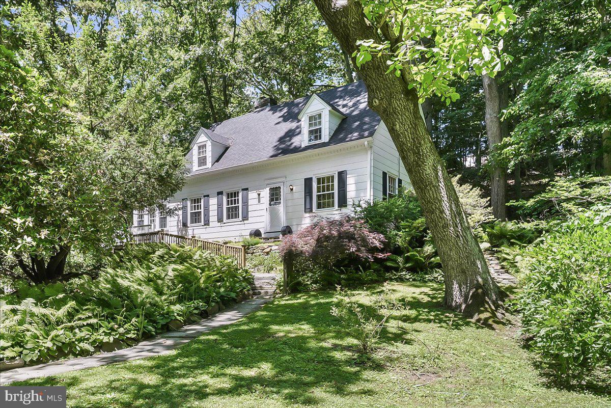 Welcome to 890 Paxon Hollow Road — a storybook cottage retreat where timeless charm, vintage character, and natural beauty come together in perfect harmony. Ideally situated between Broomall and the vibrant heart of Media, this enchanting property feels as though it has been lifted from the pages of a classic fairytale. Built in 1940 and lovingly maintained through the years, this captivating two-story cottage and detached guest house offers a rare opportunity to own a home rich in warmth, personality, and charm.  Nestled alongside picturesque Trout Run, a tranquil tributary of Crum Creek, the setting is nothing short of magical. Mature trees, soothing sounds of flowing water, and lush surroundings create a peaceful backdrop that feels worlds away from the everyday. Adding to the property's appeal is a delightful, detached guest cottage, added in 1995. Thoughtfully designed with a bedroom, office, cozy sitting area, full bath, faux wood flooring, instant hot water, and its own heating and cooling system, this versatile space is ideal as a private guest suite, inspiring artist's studio, home office, wellness retreat, or business headquarters.  Approaching the main home, guests are welcomed either by a charming paver walkway leading to the Trex deck entrance or by a stone paver picturesque stairway ascending to the original front door. Stepping inside, you'll immediately appreciate the home's authentic character. The original front door opens to reveal a warm and inviting interior where craftsmanship from a bygone era remains beautifully preserved.  The living room is the heart of the home, anchored by a stunning wood-burning fireplace that invites cozy evenings by the fire. Exposed ceiling beams, original hardwood floors, and two charming built-in closets with their original hardware create a space filled with warmth, texture, and historic appeal. Every detail tells a story and contributes to the home's undeniable cottage character.
Flowing from the living room, the dining room offers a welcoming space for gatherings both large and small. Sunlight streams through the windows while easy access to the rear deck allows indoor and outdoor entertaining to blend seamlessly. From here, you'll step into the quaint galley kitchen, where granite countertops, abundant natural light, and cottage-inspired charm create a bright and cheerful workspace that feels both intimate and inviting.  Beyond the kitchen, a classic cottage-style door leads to a hidden staircase descending to the lower level, where you'll find the laundry area, utility space, and convenient walk-out access to the backyard.  The main level also features two comfortable bedrooms and a full bathroom. Rich hardwood floors continue throughout, adding warmth and continuity to the living spaces. Upstairs, two additional bedrooms and a half bath provide flexible accommodations. The primary bedroom is especially charming, featuring dual built-in closets and numerous windows that fill the room with natural light. The fourth bedroom offers a generous living area and storage with an oversized closet and additional hidden storage space.  Throughout the home, thoughtful architectural details, original features, and cozy gathering spaces create an atmosphere that is both welcoming and unforgettable. Whether you're curling up by the fireplace, entertaining on the deck, working from the cottage, or enjoying the peaceful surroundings, every corner of this property invites you to slow down and savor cottage living.
Outside, the grounds offer endless opportunities to garden, relax, and connect with nature. With its idyllic setting, vintage character, and flexible living spaces, 890 Paxon Hollow Road is more than a home—it's a place where cherished memories are waiting to be made.