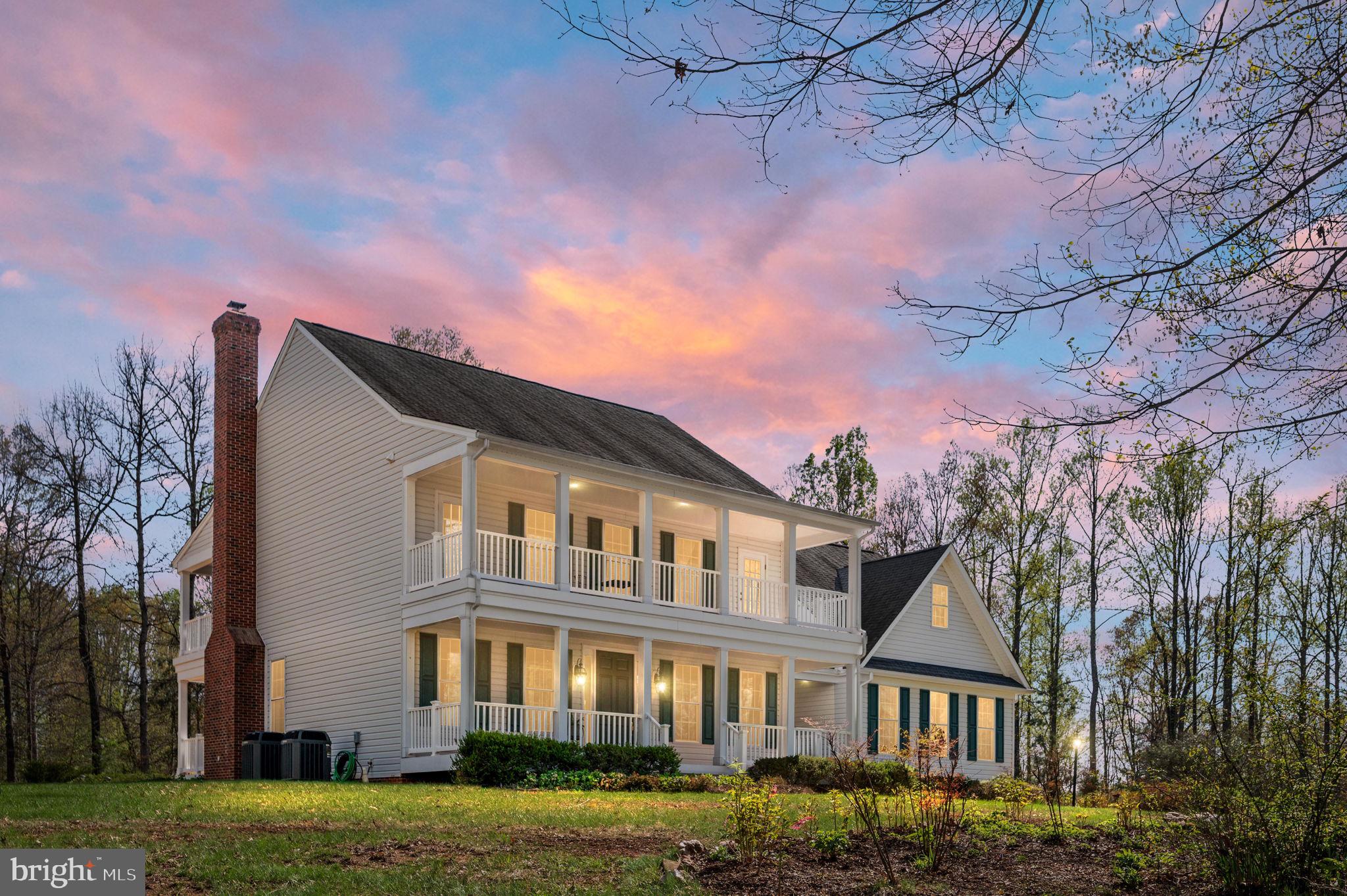 SOUTHERN CHARM abounds at this 16.94 acre country retreat!  Tucked away in a quiet rural community with no HOA this 5BR/3.5 BA custom-built home is located just minutes to downtown Culpeper.  Nothing but peace and quiet with views of the surrounding countryside from the welcoming front porch, private bedroom balconies, or covered back porch and patio.  Tastefully landscaped with many beautiful gardens, flowers, herbs, and other plantings.  Follow the path to a private pond and hilltop clearing with spectacular views.  A small creek runs along the front boundary line.  Come inside to a formal entryway, gleaming hardwood floors, front office with beautiful built-ins, and a formal dining room with gorgeous trim and crown molding.  In the back of the home is an open concept with a nice-sized family room featuring a cozy brick fireplace with a woodburning insert and a wonderful country kitchen with white cabinets, peninsula bar, granite countertops and a light and sunny breakfast nook with access to the back porch and patio.  Off the kitchen you will find a mudroom and laundry area boasting a separate entrance, utility sink and lots of pantry storage.  Don't miss the 3-car garage and workshop in the backyard.  On the upper level is a spacious primary bedroom with a walk-in closet and luxury bath boasting a soaking tub, separate shower and double vanity.  Enjoy your morning coffee from the private screened in balcony.  Two additional bedrooms share a hall bath.  At the end of the hall you will find a storage room and a private guest bedroom with its own full bath and walk-in closet.  So many things to love about this beautiful home....  Shown by appointment only, this one won't last long!