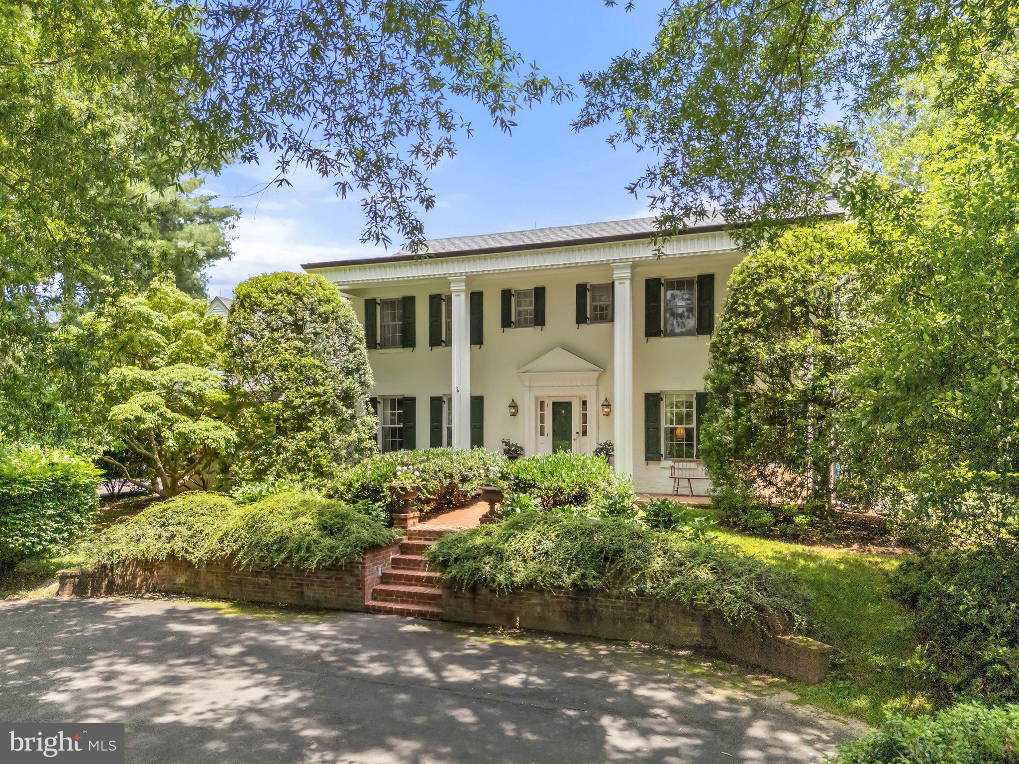 Tucked away behind two stately willow oaks in sought-after Middleburg Downs is "Northwood" offering quiet elegance just minutes west of historic Middleburg. This classic brick Colonial, built in 1977 and thoughtfully renovated over the years, features over 3,500 square feet of finished space on two levels with 4 bedrooms, 3 full baths, and 2 half baths. The front paved parking area is framed by mature boxwoods and leads to lighted brick steps and an impressive columned front porch. Inside, the traditional center-hall layout includes a formal dining room with crown molding and chair rail and a living room with a wood-burning fireplace. Just beyond is a cozy family room with wood-paneled walls, built-ins and another fireplace. The spacious kitchen offers stainless steel appliances, island, custom cabinetry and a charming breakfast nook with views of the rear brick patio, garden beds and expansive lawn. Additional main-level highlights include a screened porch with ceramic tile flooring, two half baths, a mudroom, and a laundry room with access to the garage. Upstairs, the primary suite boasts a spacious sitting area, walk-in closet and a private bath. Two guest bedrooms share a full hall bath, while a fourth bedroom—currently used as a home office—includes two walk-in closets, built-ins and its own full bath. The beautifully landscaped grounds feature mature trees, a fenced vegetable and cutting garden with a garden shed and multiple outdoor seating areas. The rear patio with a fountain offers a perfect setting for entertaining or relaxing in total privacy. Move-in ready and ideally located, Northwood is a rare find just minutes West of downtown Middleburg.