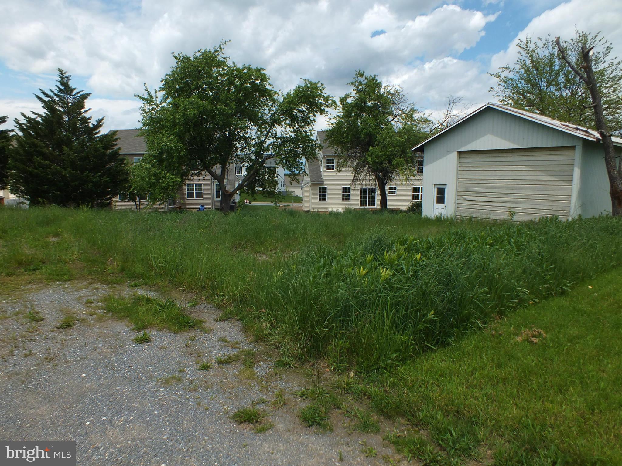 Very nice building lot off a shared drive off Houcksville Rd and close to town. Lots 10,11 & 12 combined are approximately .24 acres. There is a smallish shed on property (27' by 27'). Buyer to check with the city on public water availability and sewer hook-up.