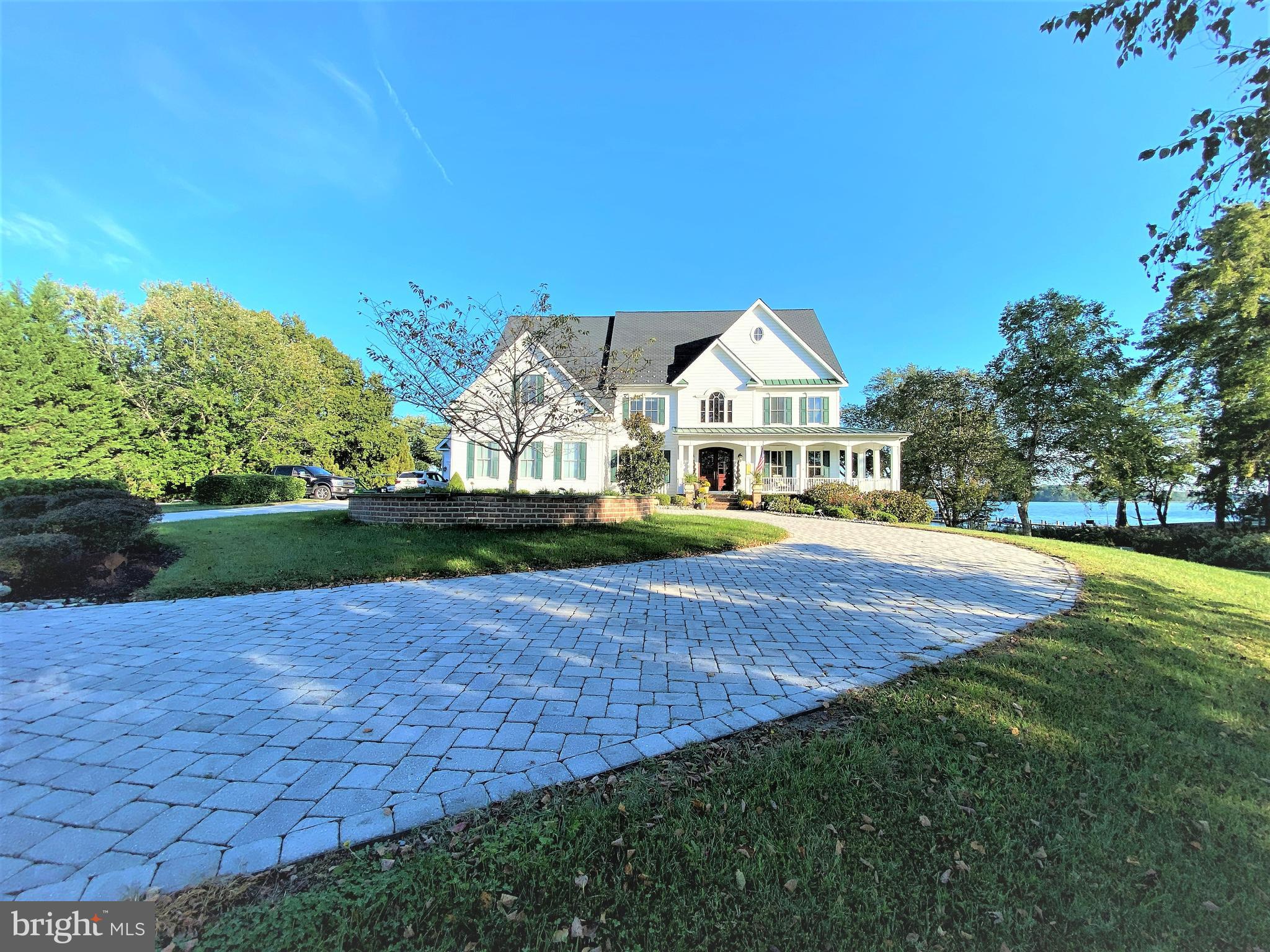 Welcome to Maryland's Eastern Shore and your dream waterfront home or weekend getaway.   Situated  on 2.29  acres with sweeping views of the Wye River, this property offers over 7400 square feet of living space.  Ten foot ceilings, paneled doors, two staircases, windows galore, extensive molding and trimwork, three car garages, two story family room and an impressive foyer with large chandelier that can be lowered.  Six/seven bedrooms, six baths, screen-in porch and a kitchen ideal for Chef's of all ages.  Large pantry, a mudroom with lots of storage and three built-in desks, separate dining room and library/office that allows for many to work out of the home. The main level offers a large bedroom with walk-in closet and full bath, plus a half bath.  The lower level features a large living room with wood fireplace,  engineered floors,  built-in cabinets, bar, area for movie theater and a pool table and a large gym.  The lower level also features a large guestroom with waterviews and an additional bedroom or storage room.  Lots of closet space and storage.  This home is ideal for entertaining large groups with a 20 by 20 gazebo, a 20 by 40 swimming pool, large waterfront yard and a private pier with deep water - ideal for boating, crabbing, fishing, swimming or just chilling. All this is located fifteen minutes to the Chesapeake Bay Bridge and close to restaurants, shopping and just a short trip to Annapolis, Baltimore, DC or Delaware.
