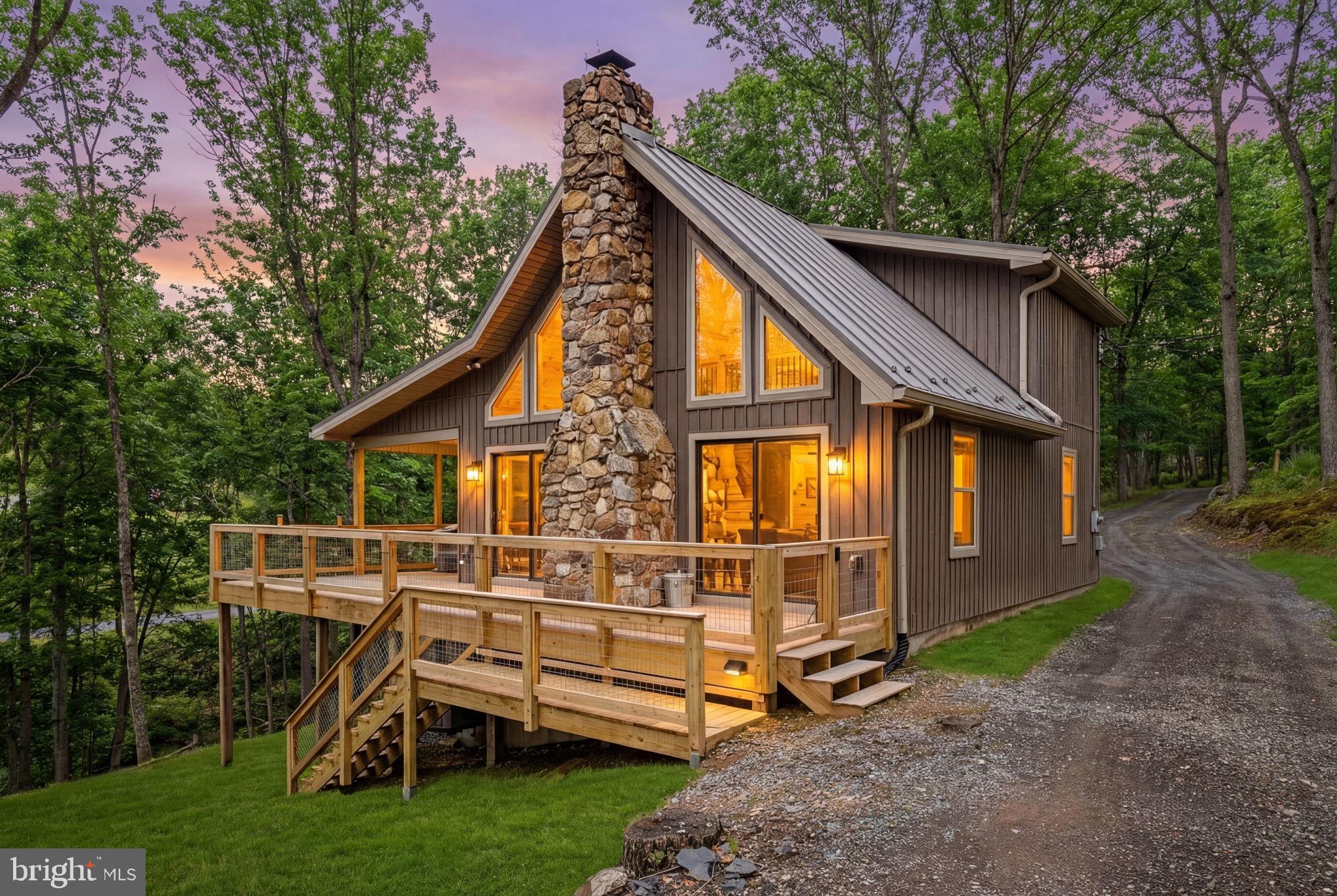 Escape to your own private retreat in The Crossing @ Great Cacapon, where rustic charm meets riverside relaxation. This inviting home features a warm stone fireplace, soaring family room ceilings, and a covered patio that lets you enjoy the outdoors in comfort. With five bedrooms, it’s perfect for a group getaway or a peaceful solo visit. Step outside to your private river access—tube, kayak, swim, or simply dip your toes in the cool water. Nestled in a gated community, this property offers both privacy and the perfect setting to unwind and reconnect with nature.  This community has a very busy schedule of events for their owners to participate in. Community events
4th July fireworks
Thanksgiving get together
River cleanup
Live concerts at the pavilion
Chili cook off
Open houses during Christmas
Corn hole tournament 
Check out their Face Book page.

Recent upgrades provide added value and peace of mind, including a new roof (March 2024), siding and gutters (March 2025), updated deck (March 2025), and new countertops (June 2025). Additional improvements include appliances (February 2023), water heater (June 2023), replaced PEX water line (June 2023), and a shed (August 2023). With major updates already completed, this rustic riverside retreat is ready for you to enjoy from day one.
The seller is offering a $4000k concessions to put a shower in the upstairs bath.