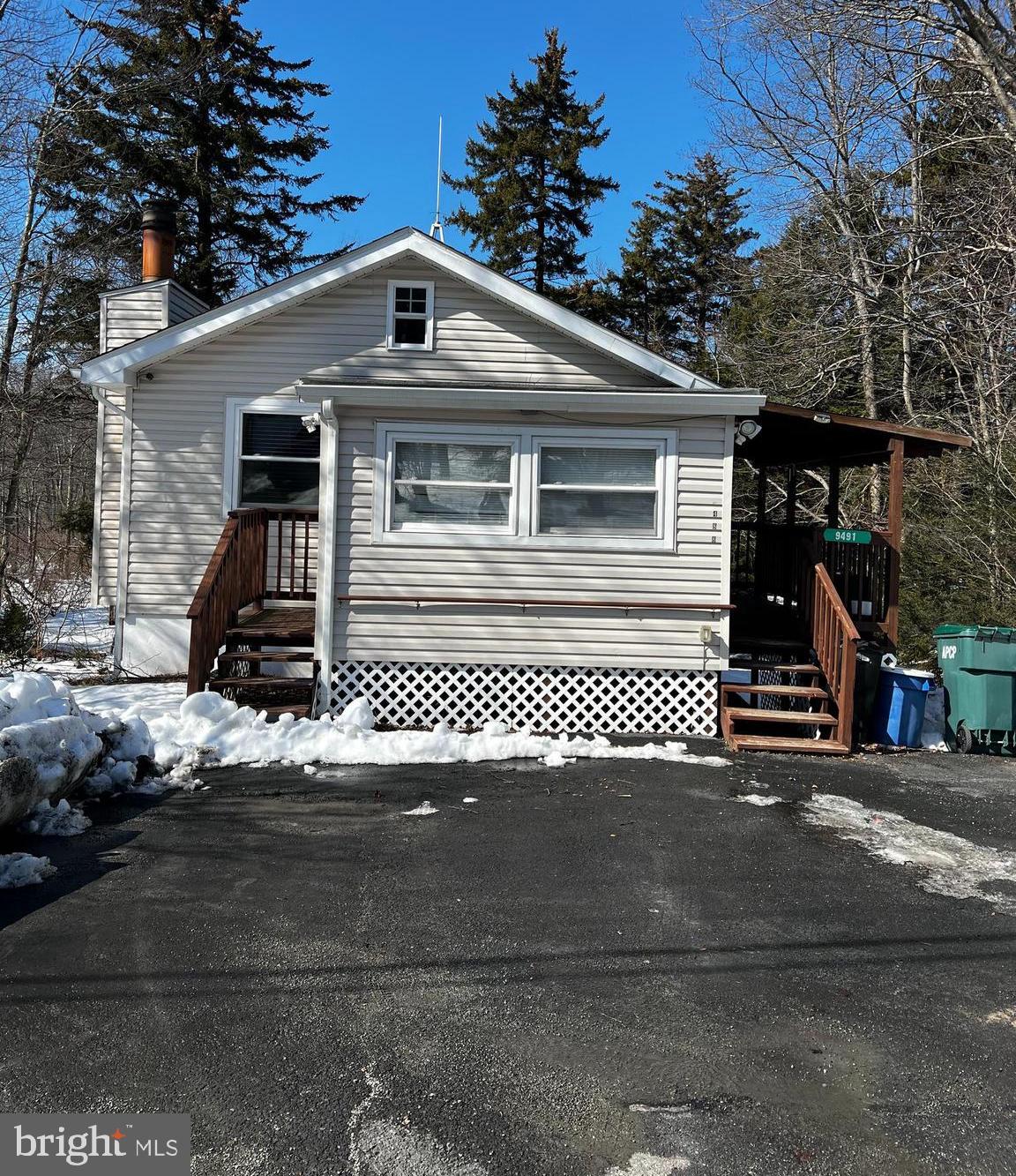 This beautifully updated 2 bedroom, 2 bathroom house is move in ready and is located in a gated community, on a paved road. Two front entrances, side deck and the exterior has vinyl siding. The interior offers hardwood and tile flooring, granite counters and stainless steel appliances with a large farm sink. Full basement with a walk out back entrance directly to your hot tub. Brand new HVAC system providing central heat and AC. The cathedral wood ceilings and skylight add a welcoming ambience to the main floor of the house. The outdoor hot tub and fire pit are a year round excuse to enjoy the very private backyard. This home is a great weekend getaway or a wonderful investment in a short term rental! Was previously used as an airbnb. Just a short 2 minute walk to the swimming pool and clubhouse. The house also comes with a whole house Generac Generator.