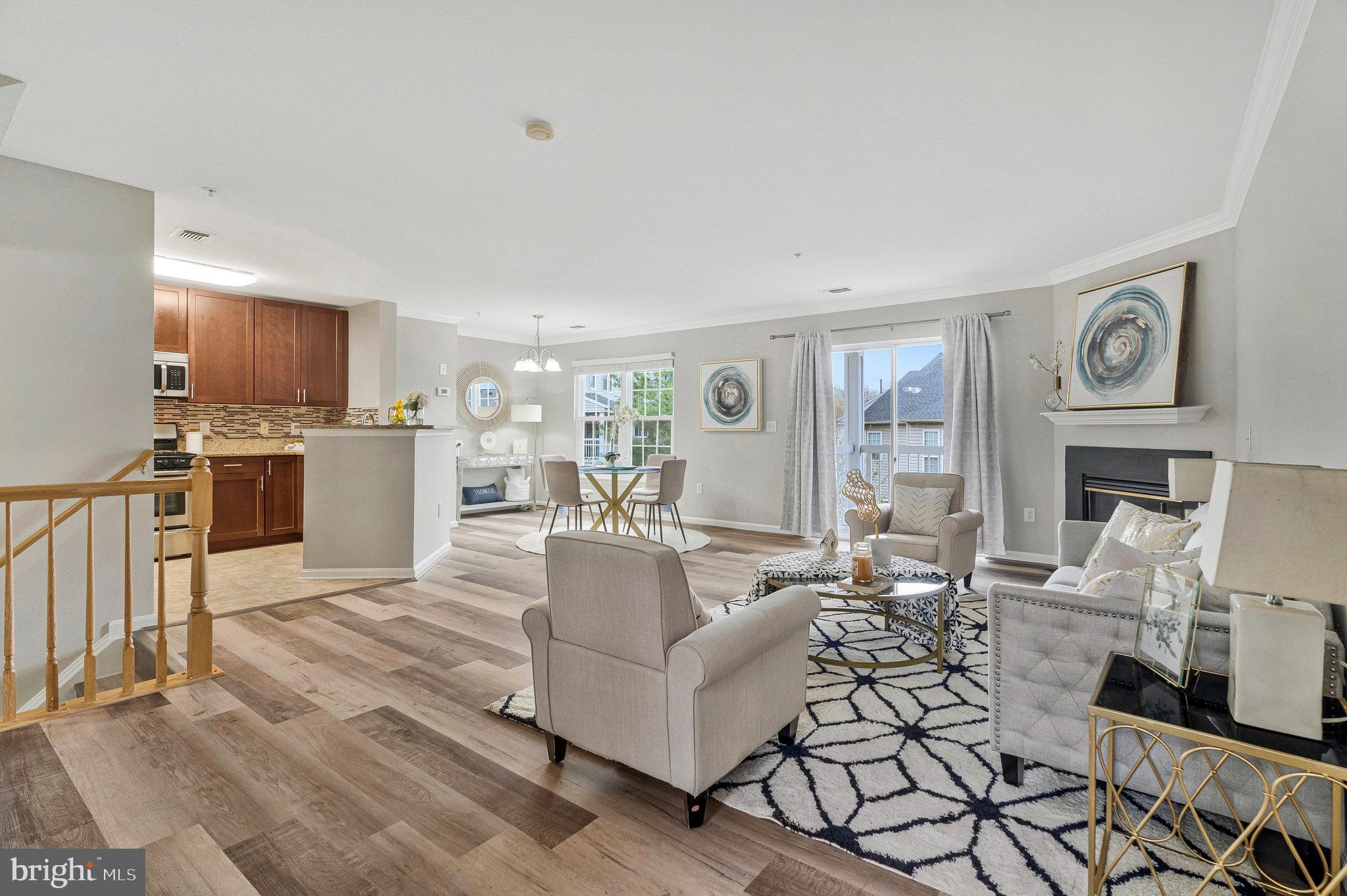 This updated townhome-style condo with a garage is located in the highly sought-after Gates of Fair Lakes community. It stands out as one of the best units in the neighborhood, offering a larger layout with windows on both the front and back, as well as the best southern exposure for ample natural light. 

The main level has an open floor plan with a sliding door that leads to a large deck, perfect for outdoor enjoyment. The dining room boasts large windows, while the living room is generously sized with a corner gas fireplace. The kitchen is equipped with stainless steel appliances, granite countertops, a stylish backsplash, upgraded 42" cabinets, and a cozy breakfast nook.

The upper level offers two spacious bedrooms and two bathrooms. Both bedrooms feature vaulted ceilings, ceiling fans with lights, and two large walk-in closets—one of which includes a window for extra natural light. The updated bathrooms offer both walk-in shower rooms and tub showers options. The private, covered deck has low-maintenance flooring and offers a beautiful view of the common area and surrounding trees.

Parking is a breeze with a garage, private driveway, and plenty of guest parking available right in front of the unit. 

Recent updates include:
- HVAC (2023)
- Refrigerator (2022)
- Dishwasher (2022)
- Water heater (2021)
- Windows in the dining room (April 2025)
- Vinyl floors (April 2025)
- Fresh paint (April 2025)

The community offers excellent amenities, including a gated, secure entry, a clubhouse, a fitness center, and an outdoor pool. 

Location is key—this condo is surrounded by several shopping centers and restaurants, including Fair Lakes Shopping Center, Fair Oaks Mall, Wegman’s, Target, and many dining options. Commuting is a breeze with easy access to the Fairfax County Parkway, Route 50, and I-66, plus a complimentary shuttle service to the Vienna Metro during rush hours.

Open house Saturday and Sunday!