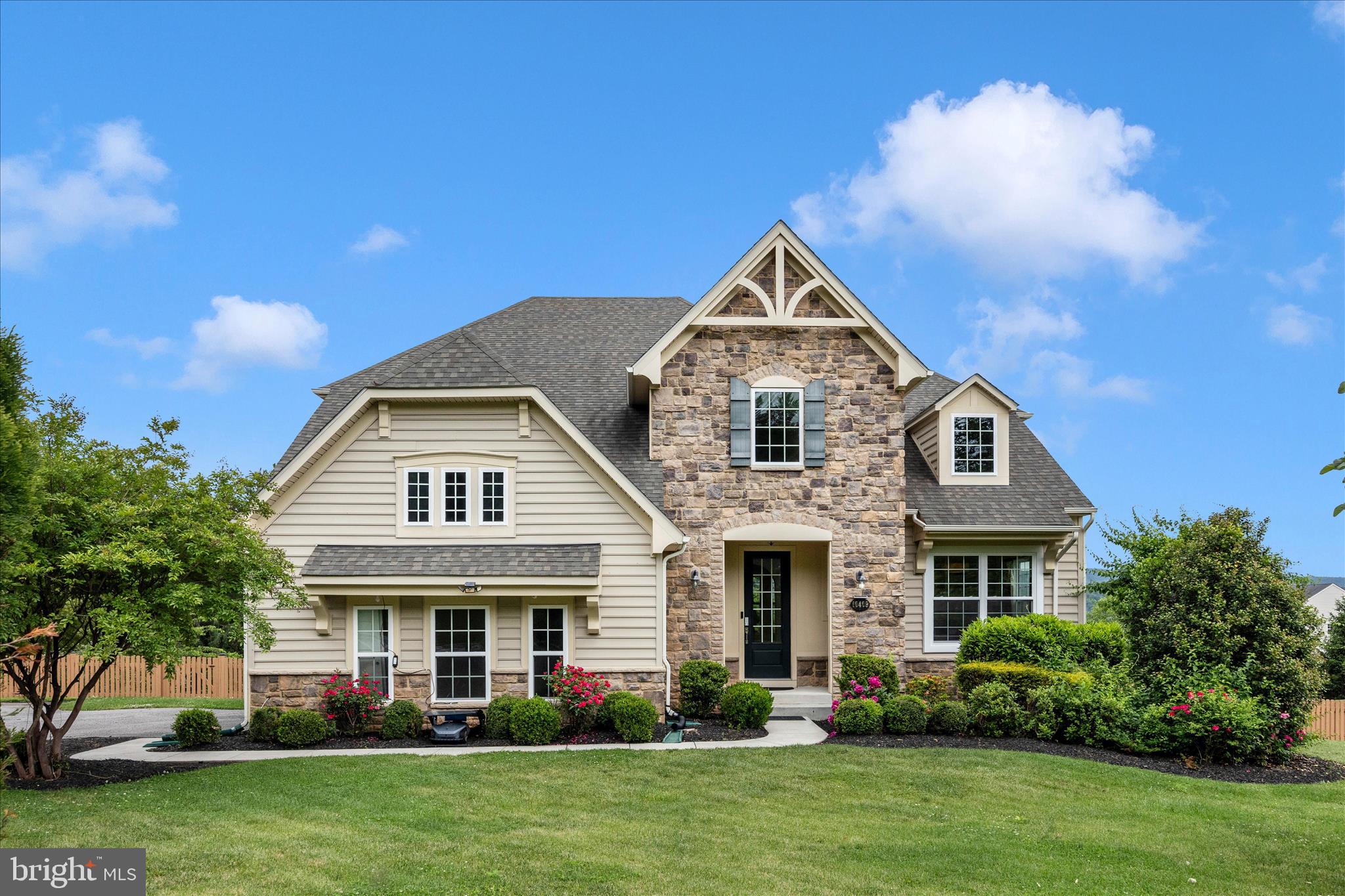 Located in the highly desirable Middletown school district, this exceptional former Drees model home offers 5 bedrooms, 4.5 baths, and over 4,660 finished square feet designed for both everyday living and entertaining. Thoughtfully appointed throughout, the home features 10-foot ceilings on the main level, arched openings, a spacious first-floor office with custom built-ins, and many other architectural appointments highlighting the home’s grandeur. The open-concept gourmet kitchen, dining area, and family room create a seamless gathering space complemented by a striking ceramic tile accent wall. Step outside to the covered rear porch with a fireplace and take in breathtaking mountain views overlooking the expansive, fully fenced backyard. Set on .86 acres of pristine landscaping with fruit trees and raised bed gardens, the outdoor space is as impressive as the interior. Large windows throughout the home fill the spaces with natural light and showcase the stunning views from nearly every room. Upstairs, the luxurious primary suite features a tray ceiling, sitting area, spa-like bath, and massive walk-in closet. Two additional bedrooms share a hall bath, while a private ensuite guest room is tucked away on its own step-down level for added privacy. The finished lower level includes a large rec room with wet bar, a flex room, fifth bedroom, fourth full bath, and walkout access to the patio. Conveniently located with quick access to I-70 and served by Blue Ribbon Myersville Elementary, Middletown Middle, and Middletown High School, this home combines luxury, comfort, and unforgettable views in one remarkable property.