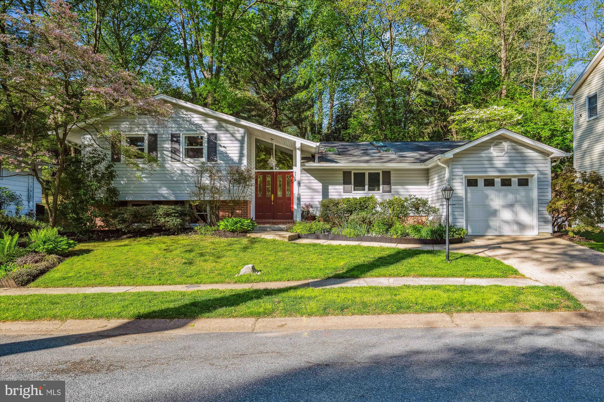 <b> OFFER DEADLINE - SUNDAY, MAY 11TH at 11:00 AM.</b><br><br>

Pride of ownership shines throughout this updated Split Level with one car attached garage, ideally located in the heart of Columbia.  The backyard is an oasis and private retreat, with lush landscaping, multiple spaces for outdoor relaxing and dining, including a stone patio, spacious deck, and a large screened-in porch with luxurious hot tub, all with stunning treed views.  The renovated kitchen provides gleaming granite counter tops and center island with room for stools, gas cooking, tile backsplash, custom built-in wine rack, spacious dining area, and is light-filled due to the 3 skylights and vaulted ceiling.  The family room is anchored by a brick wood burning fireplace with mantel, and also has a vaulted ceiling, as well as an arched transom window bringing in abundant natural light, and French doors leading to the private rear patio.  The formal dining area is open to the living room, with a slider to the rear deck, making indoor-to-outdoor entertaining seamless.  Gorgeous hardwood floors flow throughout all living spaces on the main level.  On the upper level, you will find four generously sized bedrooms, including an impressive owner’s suite, which has been expanded due to an addition on the rear of the house. The owner’s suite features newly refinished hardwood floors, generous closet space, French doors to the screened-in porch, and a gorgeously renovated en-suite bath with quartz vanity and impressive oversized shower with upgraded floor to ceiling porcelain tile and built-in bench.  The lower level features an expansive rec room with brand new neutral carpet and a 3rd full bath, all freshly painted, as well as a large storage room.  Substantial updates include HVAC, roof, hot water heater, and skylights.  This one has it all – high quality updates throughout, abundant space, and amazing outdoor spaces!