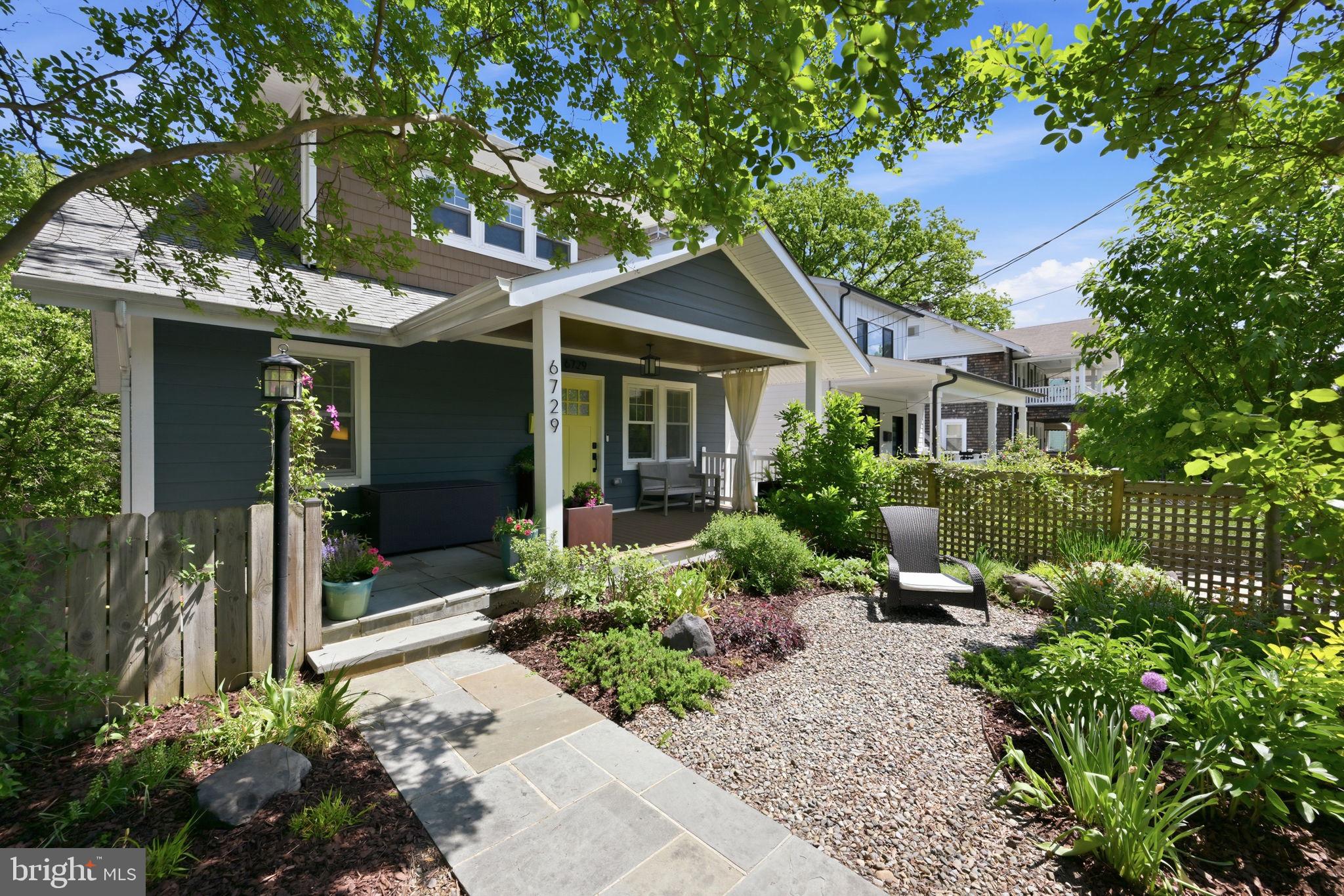 Tucked away off a quiet access road, this beautifully expanded and renovated home offers the best of both worlds: the convenience of Eastern Avenue without feeling like you are right on it.

With over 3,400 finished square feet, it lives large. A charming, fully fenced garden oasis welcomes you out front, setting the tone before you even step inside. The main level features hardwood floors, abundant natural light, a fireplace, and an open, easy flow from the living room to the dining area, kitchen, and sun-filled family room. The kitchen is outfitted with Shaker cabinetry and professional-grade stainless steel Thor appliances, while the family room opens to the upper-level deck overlooking the expansive backyard.

Perched above the yard, the rear of the home lives like a treehouse, with leafy views in every direction and the soft soundtrack of birds singing. Whether you’re enjoying your morning coffee on the upper deck or unwinding on the screened-in porch below, there’s a sense of being tucked away in nature.

Two bedrooms and a full bath complete the main level, along with in-ceiling Bluetooth audio that adds an elevated touch to everyday living and entertaining. Upstairs, two spacious bedrooms with vaulted ceilings share a beautifully finished full bath with a soaking tub, glass shower, double vanity and a linen closet. A hallway laundry closet adds convenience, and the primary bedroom also includes in-ceiling Bluetooth audio.

The walk-out lower level is the true game changer. With a bedroom, den, a full bath, kitchenette, dining area, living room, laundry room, separate HVAC, private entrance, and access to the rear screened porch, it offers incredible flexibility as an in-law suite, guest space or work-from-home space.

Outside, enjoy multiple places to gather and unwind: a covered front porch, composite rear deck, screened-in lower porch, huge backyard, and off-street parking.

Rarely do you find this much finished space, outdoor living, and flexible functionality in Takoma Park.

Square footage is approximate and should not be used for property valuation.