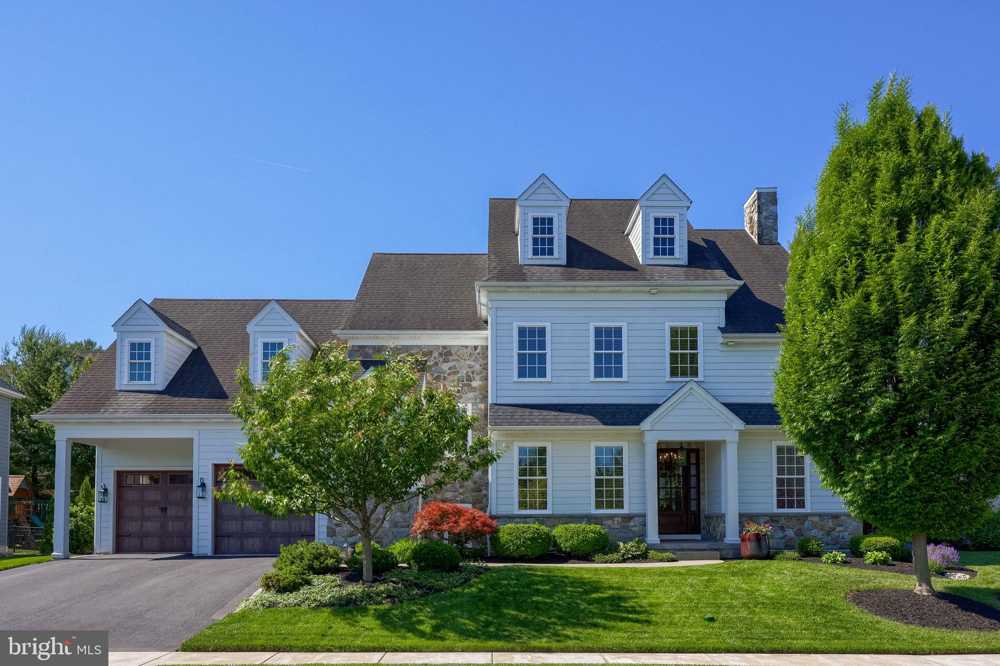 Picture-perfect curb appeal welcomes you to this stunning Costello-built luxury residence in the desirable Spring Haven neighborhood of Manheim Township. Meticulously maintained & loaded with upgrades, this 4 bedroom, 4 full bath & 1 half bath home with 3-car garage w/tandem bay, features extensive millwork, crown molding, wainscoting, and engineered hardwood & tile flooring throughout the 1st floor. An open floor plan with 10' first floor ceilings. The covered front porch and beautiful front door open to a warm & elegant foyer that sets the tone for the refined finishes throughout the home. From here, the kitchen, dining area, wet bar & living room flow seamlessly together, creating an ideal layout for both everyday living and effortless entertaining. The gourmet eat-in kitchen features a huge island with breakfast bar, granite countertops, tile backsplash, stainless steel appliances, commercial-style 6-burner Bertazzoni gas cooktop w/griddle, double wall ovens, soft-close dovetail drawers, custom pull-outs, tall wall cabinetry, and an expansive sink window overlooking the private backyard & filling the space with natural light. Adjacent to the dining area, Costello’s signature wet bar connects the main living spaces and features granite counters, tile backsplash, and beverage cooler. The spacious living room showcases a corner gas fireplace and a triple window that enhances natural light throughout. A sliding door with transom opens to an exceptional outdoor living area complete with a covered patio featuring a cathedral wood ceiling & decorative open gable detail overlooking the backyard, perfect for relaxing, morning coffee & alfresco dining, plus additional patio space with a cozy built-in firepit. The elegant formal dining room is ideally positioned with seamless access to the kitchen & wet bar. A private 1st floor office with glass French doors and a powder room with shiplap accents are located just off the foyer, creating a natural transition into the main living spaces. A mudroom between the kitchen & garage offers built-in bench, shelving, coat hooks, & walk-in pantry. An open staircase with wainscoting leads to the 2nd floor central hall. The primary suite is a true retreat with tray ceiling & a luxury bath complete with large walk-in tile shower, whirlpool tub, double vanity with granite, private water closet, & spacious walk-in closet with built-ins. Three additional bedrooms each feature 9’ ceilings, private en-suite baths & walk-in closets. The 2nd floor laundry includes cabinetry, granite counters, tile backsplash, & open shelving. Additional highlights include a built-in ceiling speaker system in select areas, central vacuum, and a rear garage door providing easy access to the backyard.  A large unfinished basement w/bath rough-in provides excellent storage & future expansion potential.  Ideally located between Lancaster & Lititz in the heart of the Manheim Township School District, this home offers exceptional convenience to schools, parks, dining, shopping, major routes, and the Weaver Road Manheim Township Athletic Complex, while still maintaining a quiet neighborhood setting.  A truly refined residence offering comfort, craftsmanship, & timeless design.