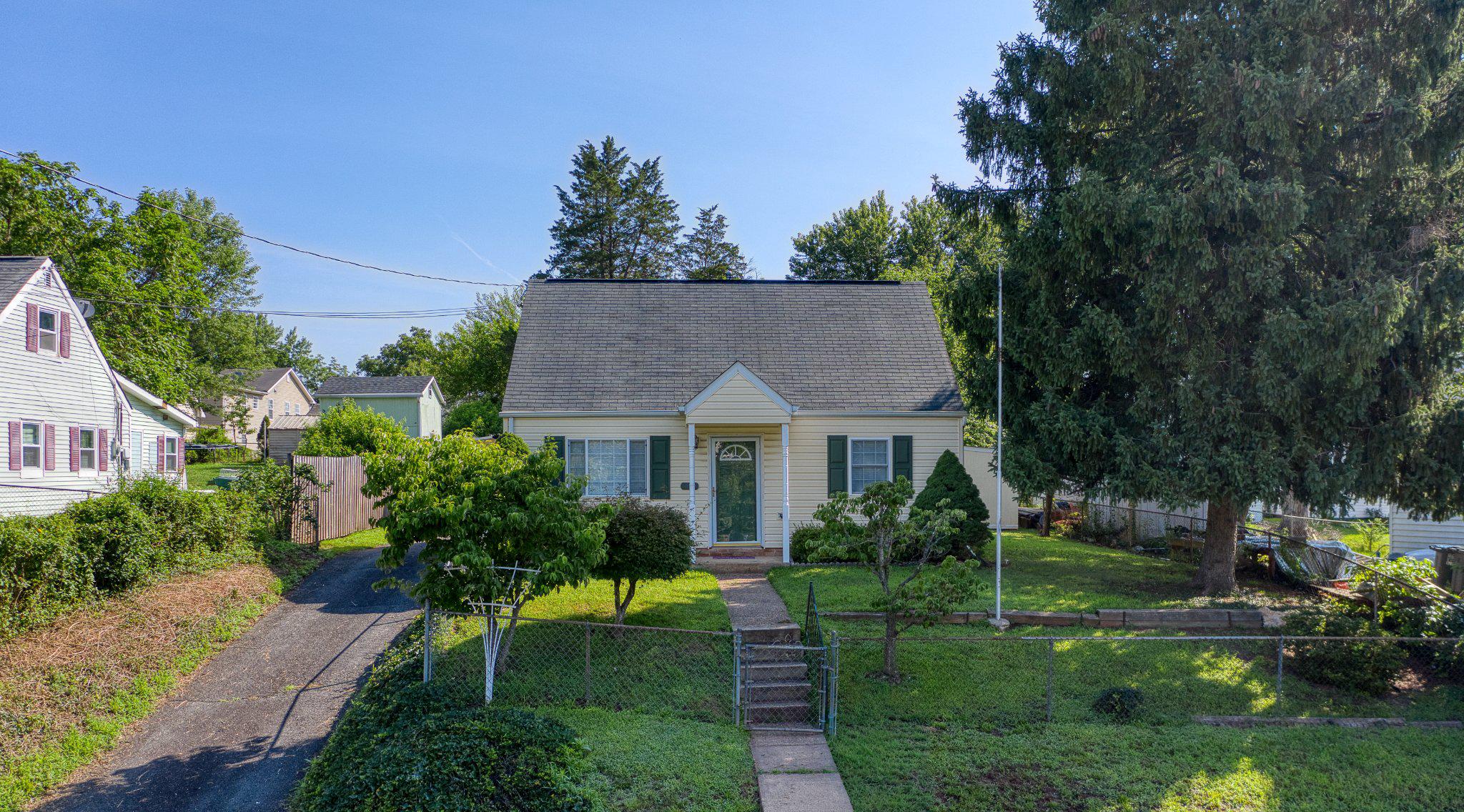 Charming and move-in ready, this adorable 3BR/1.5BA Cape Cod is the perfect place to call home! Whether you're looking to downsize or purchase your first home, this well-maintained property offers comfort, convenience, and plenty of outdoor space to enjoy. Situated on a spacious in-town lot, the fully fenced backyard provides privacy and endless possibilities for gardening, pets, entertaining, or simply relaxing outdoors. Additional exterior features include a screened pavilion, storage shed, carport, and off-street parking.

Completely rebuilt in 2010, the home offers a functional floor plan with a spacious living room filled with natural light. The kitchen features abundant cabinet and countertop space, gas cooking, and easy access to the main-level laundry area. Two bedrooms and a full bathroom are conveniently located on the main level, while the upper level offers a third bedroom, half bath, and a versatile den that makes an ideal home office, playroom, or reading nook. A neutral color palette throughout makes it easy to personalize and move right in.

Conveniently located close to schools, shopping, restaurants, medical facilities, and everyday amenities, this charming home offers the perfect combination of small-town convenience and comfortable living. Don't miss this wonderful opportunity to own an affordable, move-in ready home with a great backyard and plenty of outdoor living space! No HOA!