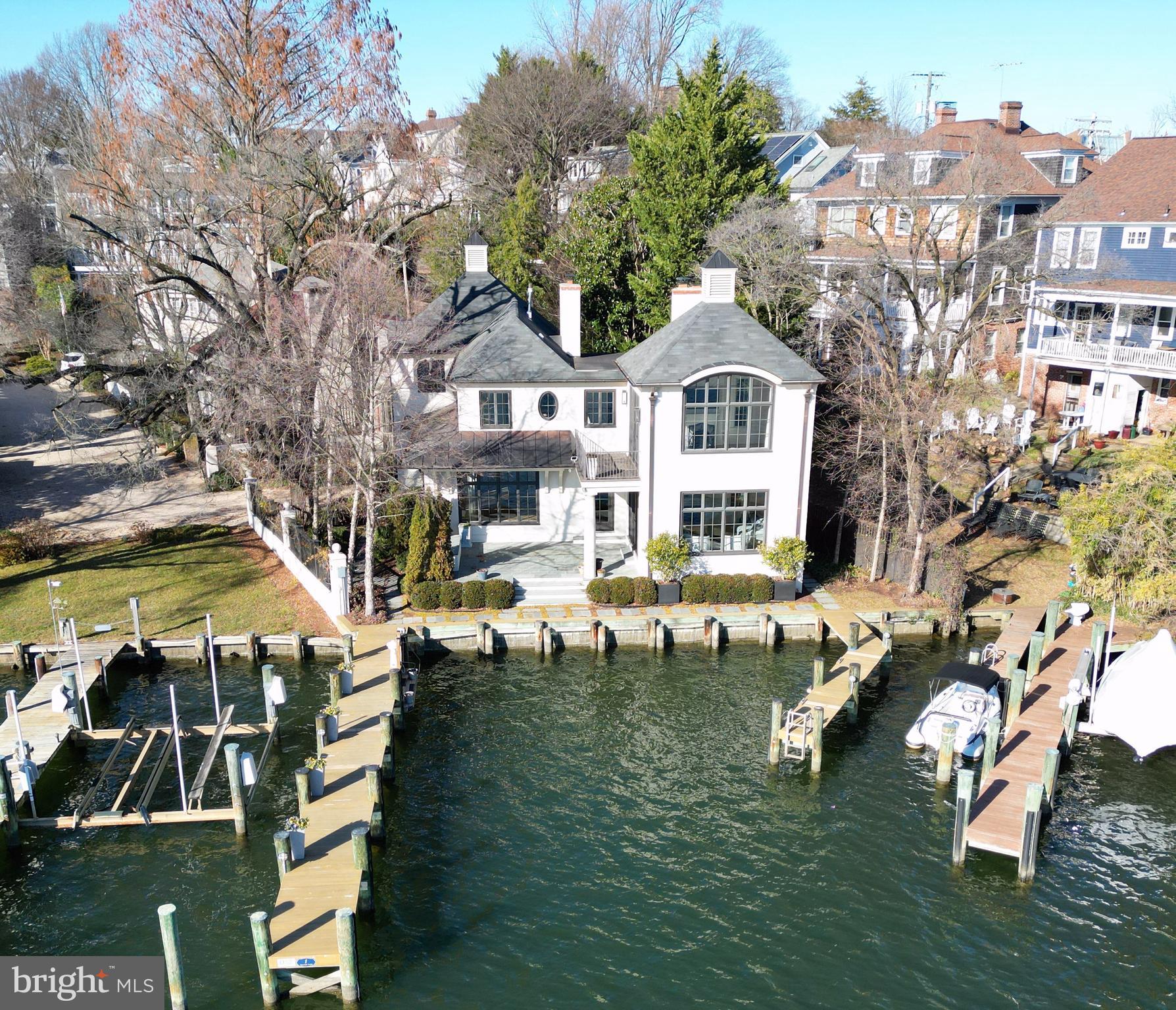Stately French Villa on Spa Creek in downtown Annapolis! This jewel box of a home was designed and built by a renowned local architect as the culmination of an award-winning career. 

Offered completely turn-key, this exceptional residence conveys fully furnished and thoughtfully appointed—including furniture, fully equipped kitchen, linens, etc —allowing you to arrive with nothing more than a suitcase and begin enjoying the Annapolis waterfront lifestyle from day one. 

The unrivaled architectural detail, exquisitely curated finishes, and sweeping views across Spa Creek elevate this residence into a class of its own. Privately positioned at the end of a quiet street within one of downtown’s most coveted waterfront enclaves, this 3-bedroom, 3.5-bath retreat is equally suited as an elegant weekend escape or a full-time residence.

Dramatic Palladian windows bathe the interiors in natural light while perfectly framing the ever-changing harbor views. At the heart of the home, the gourmet kitchen—appointed with custom cabinetry, premium appliances, and a striking designer hood—flows seamlessly into both the formal living room and inviting family room, each enhanced by a gas fireplace and captivating water vistas. A main-level secondary primary suite offers comfort and flexibility for guests of all generations.

Upstairs, the extraordinary waterside primary suite features vaulted ceilings, walls of glass, a gas fireplace, spa-inspired bath with soaking tub, and a custom dressing room with center island. A private balcony provides the ideal perch for sunrise coffee or sunset reflections overlooking Spa Creek, Annapolis Harbor, and Eastport.

Designed for effortless waterfront living, two deep-water piers with approximately 9 feet of MLW accommodate substantial vessels, with immediate access to the Severn River, the Chesapeake Bay, and beyond.  Walkable to the shops, restaurants, and charm of downtown, this rare offering delivers convenience, privacy, elegance, and ease in one remarkable package. Welcome Home!