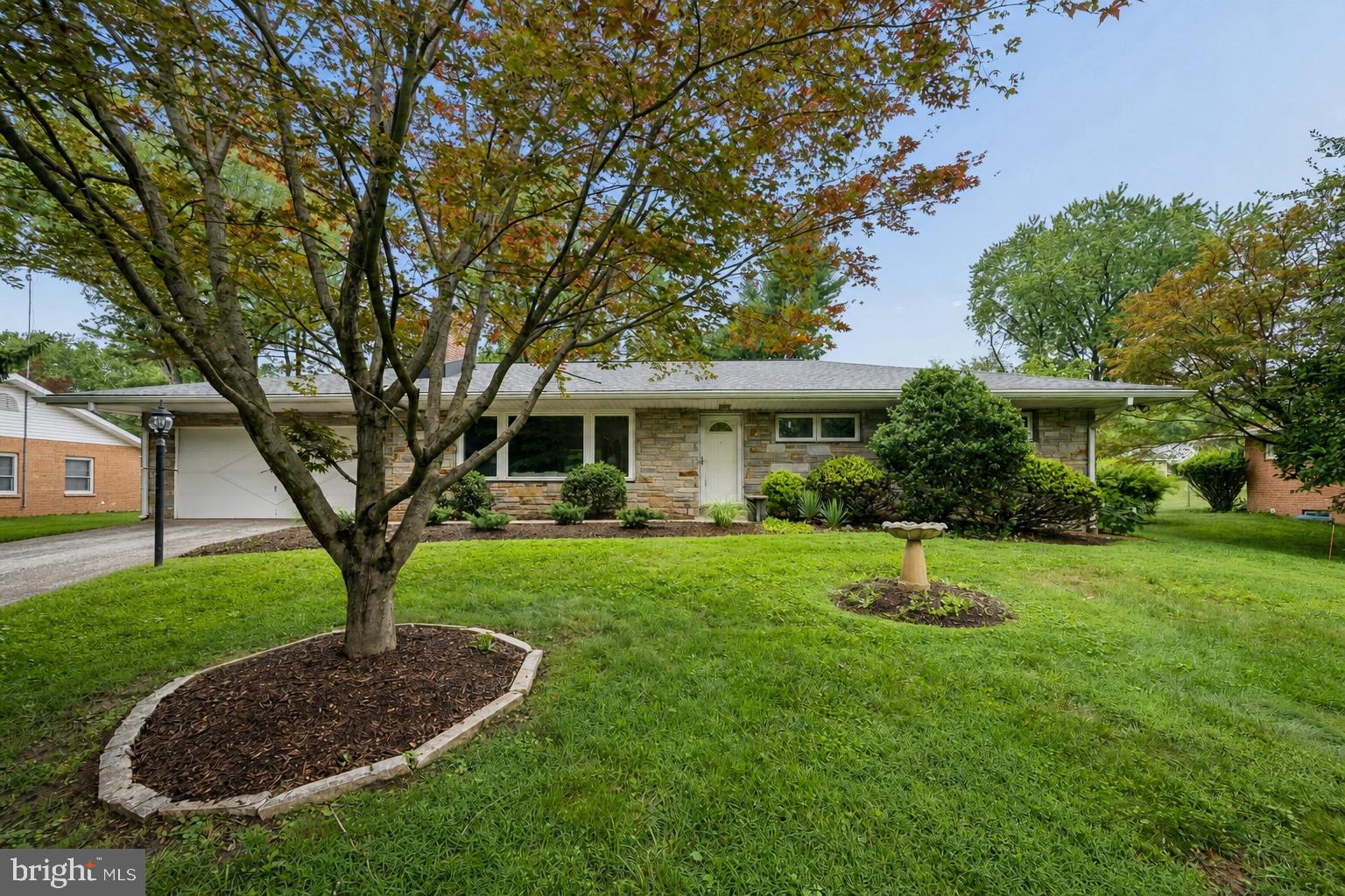 Welcome to 9710 Hillsmere Road, a beautifully maintained stone-front rancher nestled on a premium lot in the highly sought-after Glen Brook community of Ellicott City. Offering over 2,900 square feet of finished living space, this spacious home features 3 bedrooms, 3 full bathrooms, timeless character, thoughtful updates, and the convenience of one-level living.

Step inside to discover red oak hardwood floors, fresh paint, replacement premium vinyl windows, and an updated kitchen that serves as the heart of the home, perfect for both everyday living and entertaining. The spacious primary bedroom offers a peaceful retreat with a beautifully renovated en-suite bathroom featuring a walk-in shower. Two additional generously sized bedrooms provide flexibility for family, guests, or a home office. A convenient main-level laundry room and a cozy wood-burning fireplace complete the inviting main level.

The finished lower level expands your living space with a large recreation area, a second wood-burning fireplace, a full bathroom, and endless possibilities for a guest suite, home gym, media room, or playroom.

Outside, enjoy the home's elevated setting, mature landscaping, and attractive stone façade that create exceptional curb appeal. The oversized two-car garage provides ample storage, while the roof was replaced in 2018, and the home's replacement vinyl windows provide improved energy efficiency and low-maintenance living.

Ideally located just minutes from shopping, dining, parks, and everyday conveniences, with quick access to Routes 40, 29, 100, and I-70, this home combines comfort, space, and an unbeatable location in one of Howard County's most desirable neighborhoods.

Don't miss your opportunity to make this Glen Brook gem your next home!