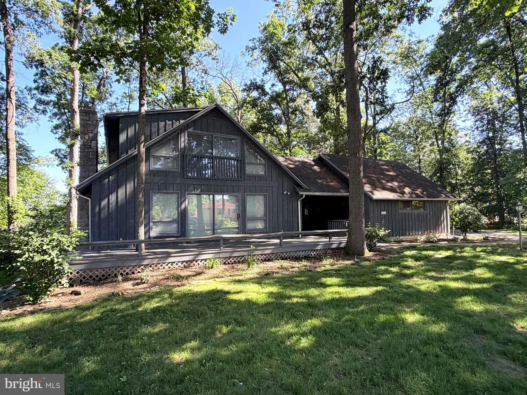 Check out this 4-bedroom, 3 full bath contemporary home tucked away on a wooded lot in the Penn National community! Enjoy plenty of natural light throughout, multiple sliding glass doors, and both front and rear decks to relax and take in the peaceful setting. The main level features a spacious living room with a stone fireplace, while the lower level offers a large family room, fourth bedroom, full bath, workshop area, and walkout access. Laundry hookups are available on both levels for added convenience. The attached oversized is connect to the home by an enclosed sunroom area. ** ADDITIONAL PHOTOS TO COME **