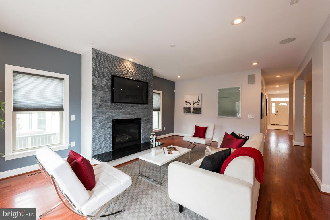 Modern and stylish. Over 4,200 sf custom built, contemporary designed 7 bedroom, 5 bathroom home in the heart of Arlington. Half a block to dining, shopping, library, and farmers market. The largest bedrooms on the market. Loaded w/ the latest in-home technologies (AV, lighting, HVAC). Full in-law suite on the walkout lower level. 3 garage spaces (his, hers, +toy) and ample off street parking