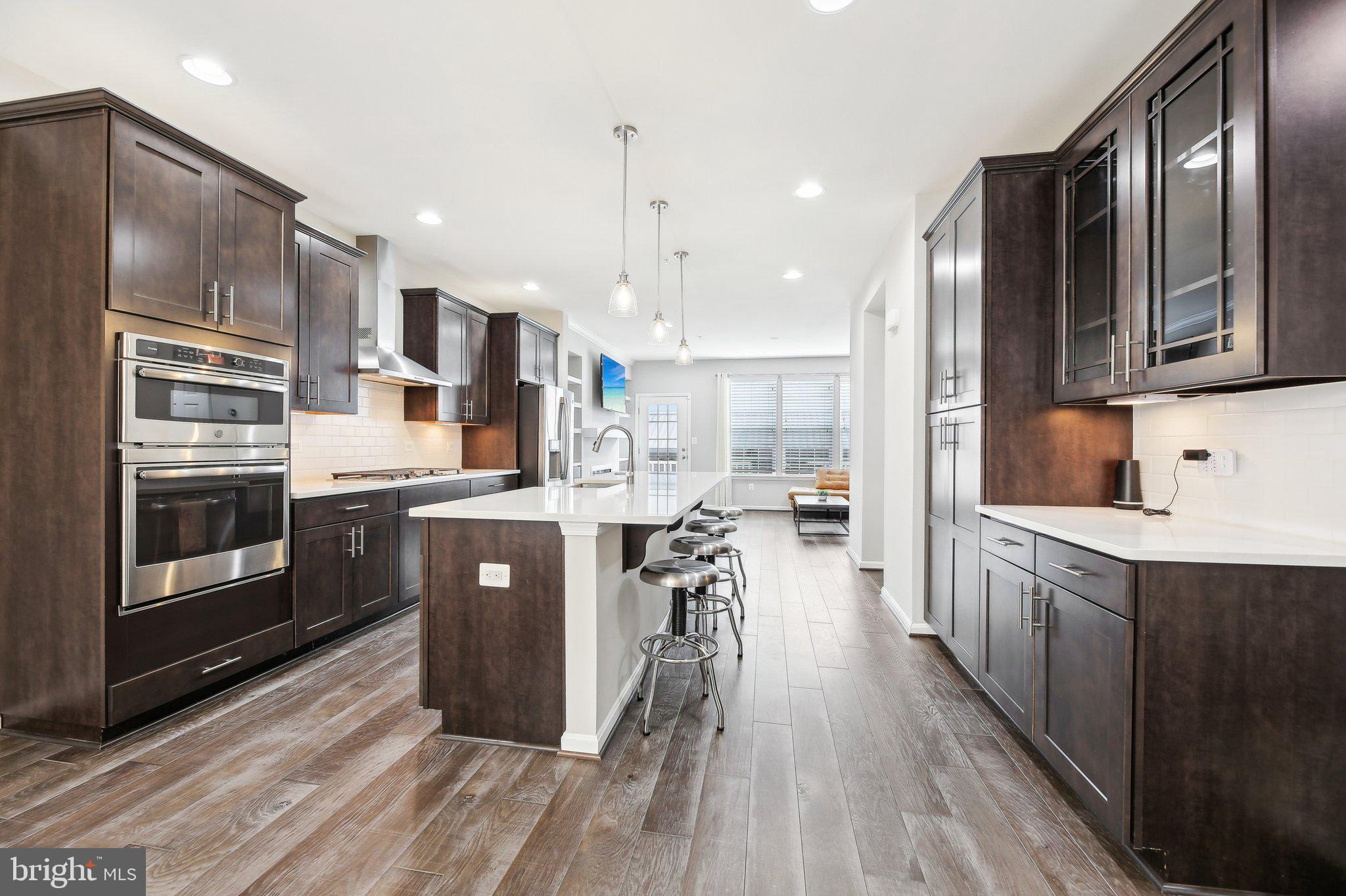 Here’s your chance to own this Impressive, rarely available 4 LEVEL townhome with a Prime Location in the sought-after Hampden neighborhood. Features 4 bedrooms, 3.5 baths, open layout, recessed lighting, Gourmet Kitchen with upgraded stainless steel appliances, built-in oven and cooktop, extra large range hood, double deep farm sink, tile backsplash, plenty of cabinetry and aa huge center island with breakfast bar. The open concept floorplan is great for entertaining! The living room features a beautiful accent wall with built in gas fireplace and custom shelving. The trex deck off of the living room is the perfect spot to unwind after a long day. The main level bedroom and adjacent bathroom is perfect for guest and privacy. The upper level boasts 3 spacious bedrooms including the primary suite with private bathroom. Head up to the 4th level where you’ll find a Bonus Loft space that leads out to the Expansive Wrap Around Rooftop Deck! Enjoy amazing city views including the downtown Baltimore 4th of July fireworks display. Parking is a breeze with your 2 car garage Plus 2 car parking pad! This convenient location is close to all of the Hampden restaurants and shops! Nothing to do here but move in and enjoy. Welcome home!