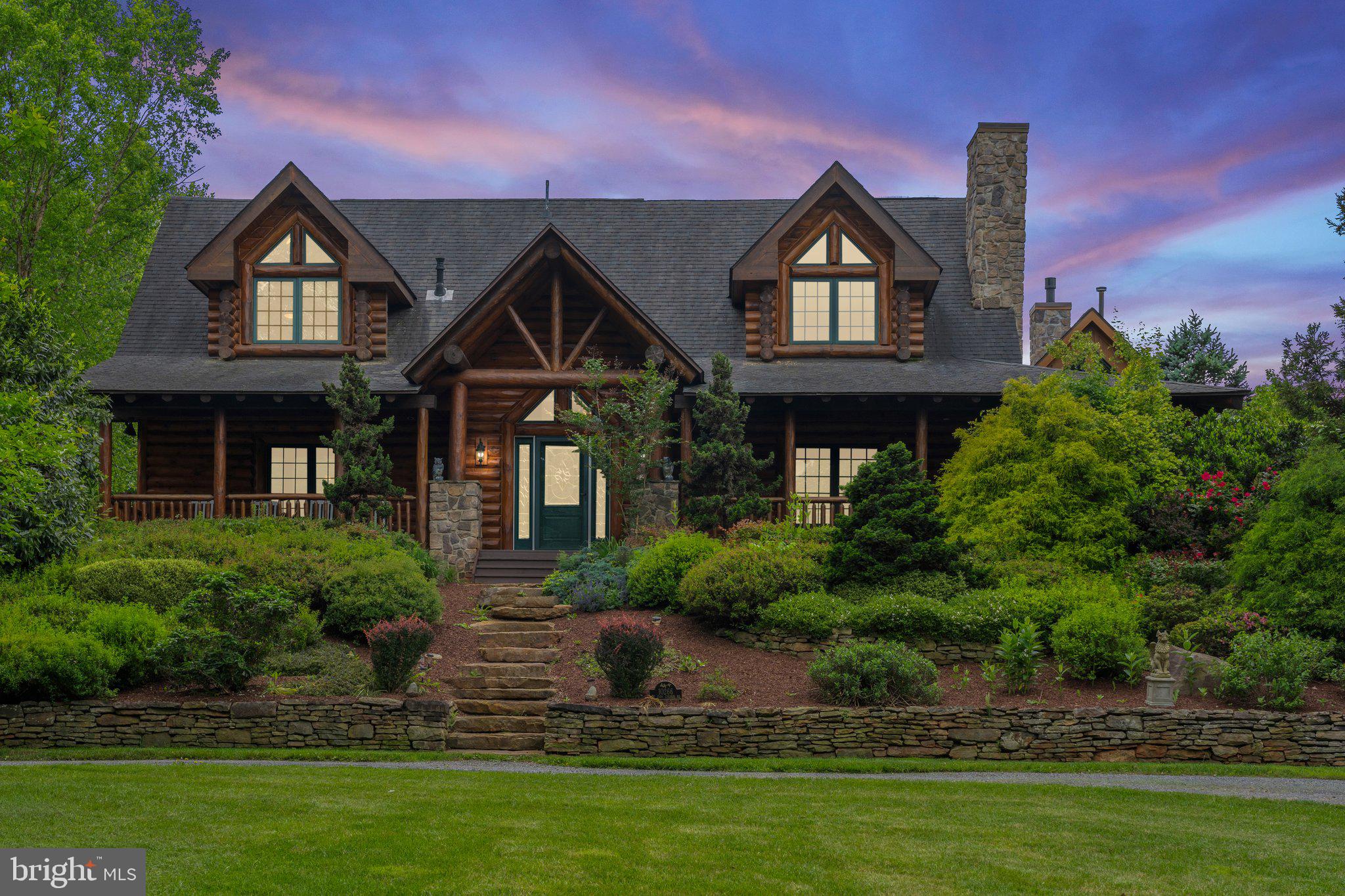 Escape to your own private haven nestled on over 35 acres of breathtaking natural beauty. This stunning log cabin retreat combines rustic charm with modern luxury, offering a serene sanctuary just moments from civilization. 
Step inside to discover a meticulously crafted 3-bedroom, 3.5-bathroom home boasting a spacious open floor plan, vaulted ceilings enhanced by exposed beams, and two inviting stone fireplaces. The heart of the home is the custom kitchen, complete with a large island, granite countertops, and brand-new stainless-steel appliances.
Relaxation awaits in the adjacent sunroom, where expansive windows and skylights flood the space with natural light, perfect for indoor gardening or simply unwinding with a good book. The main level primary suite offers a private oasis with a luxurious ensuite bathroom, featuring a tile shower, separate jetted tub, and access to a covered porch overlooking a tranquil Koi pond (Koi included)
Upstairs, two additional bedrooms, an office, and a large full bath provide ample space for family and guests. The basement level offers endless entertainment possibilities with an oversized recreation room, home gym, another full bath and a game room complete with the included billiard table. Also included is a whole house generator and water treatment system.
Outside, explore miles of private walking trails winding along the picturesque Muddy Run stream, or practice your swing from the tee box  or on the putting green. Sports enthusiasts will appreciate the basketball court with tennis wall, while car aficionados will love the detached conditioned four-car garage with bonus room alongside a second two-car garage.
With a separate 21.8 acre wooded lot included, eligible for division according to current zoning ordinances, the possibilities are endless. Don't miss your chance to experience true log cabin living at its finest. Fiber optic internet available, no HOA/covenants.
