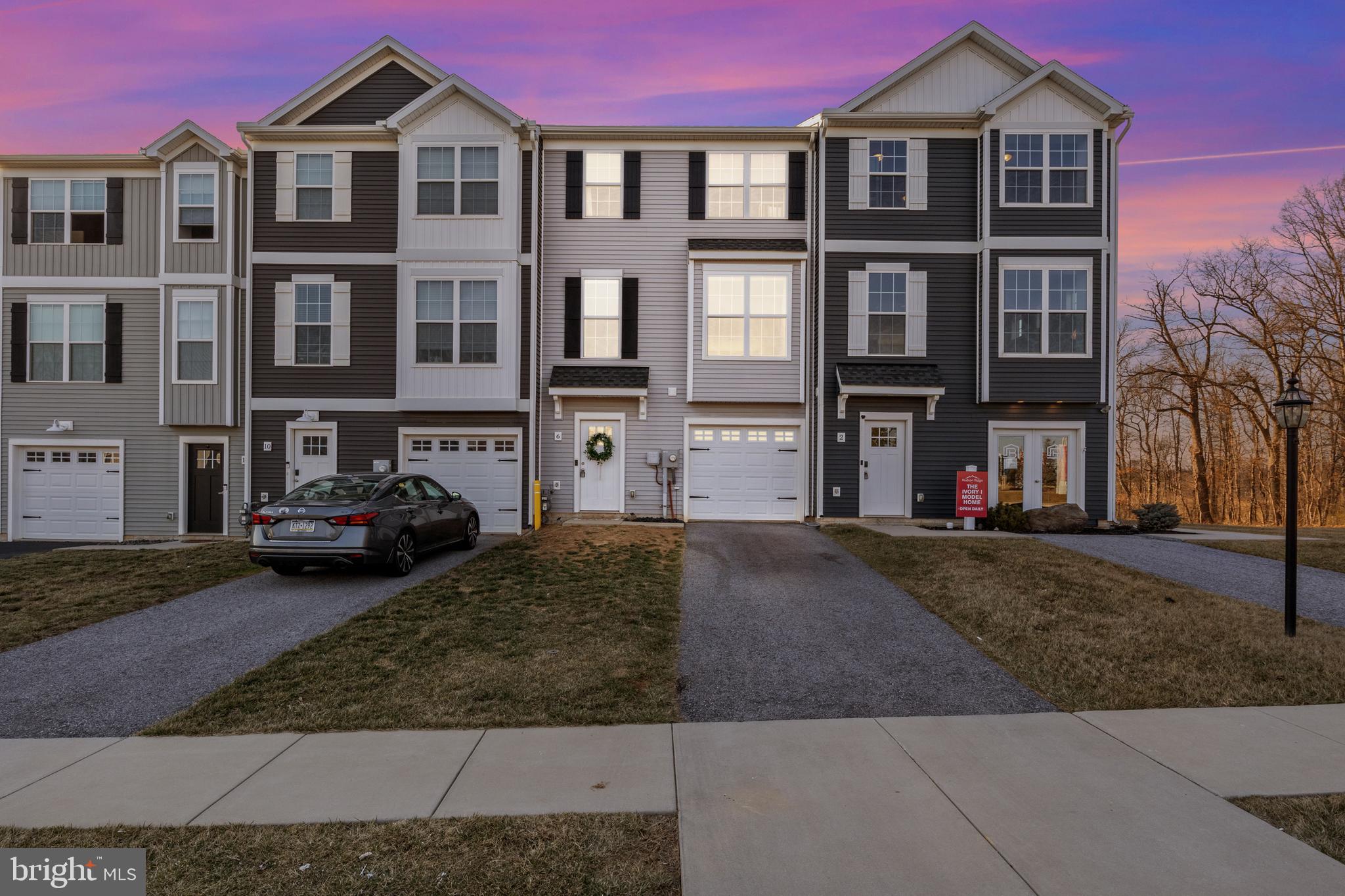Buyer got cold feet! Back on market at no fault of its own with a bank approvable price! Stunning 3-Bedroom Townhouse in Dallastown School District – Immaculate & Move-In Ready! Welcome to this beautifully maintained three-bedroom, 2.5-bathroom townhouse, built in 2019 and located in Dallastown School District. From the moment you arrive, you’ll appreciate the care and attention that has kept this home in pristine condition. Step inside to discover a bright, open-concept main level featuring modern finishes and plenty of natural light. The spacious kitchen boasts stainless steel appliances, ample cabinetry, and a center island, perfect for meal prep and entertaining. Just off the kitchen, sliding glass doors lead to a private deck, offering a perfect space to relax or enjoy outdoor dining with an exceptional view of the sunset each evening. Upstairs, the primary suite is a true retreat, complete with a walk-in closet and an en-suite bathroom. Two additional bedrooms provide flexibility for family, guests, or a home office. A second full bath and conveniently located laundry area complete the upper level. The attached garage offers secure parking and additional storage, while the lower level features a welcoming entryway, access to the garage, and a cozy family room with outdoor access. This home is truly move-in ready—immaculate, well-kept, and designed for modern living. Conveniently located near shopping, dining, and major commuter routes, this is an opportunity you won’t want to miss! Schedule your showing today!