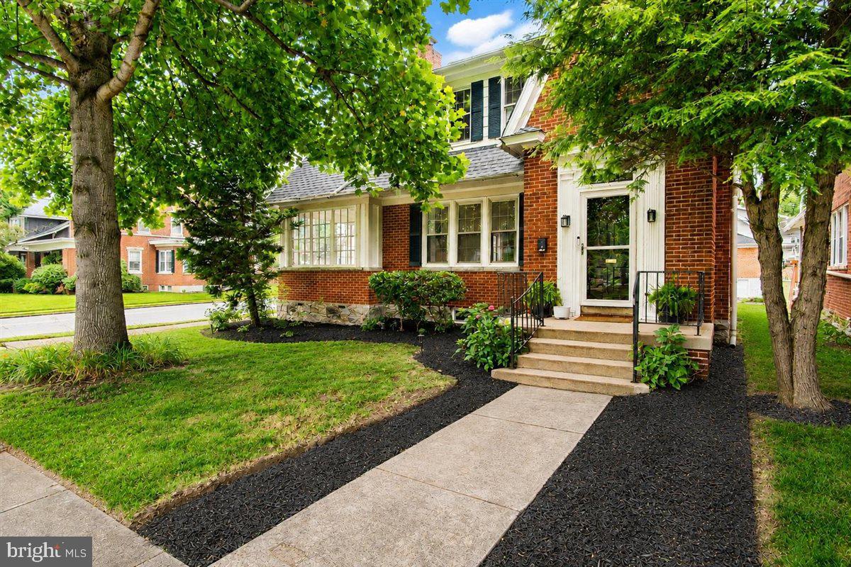 Timeless Character, Thoughtful Updates & Unmatched Charm in the North End! Welcome to 1214 Oak Hill Avenue, a stunning Tudor Revival-influenced Colonial where historic character and modern convenience come together beautifully. Situated on a charming corner lot in one of Hagerstown's most beloved neighborhoods, this home offers over 2,100 square feet of above-grade living space filled with warmth, personality, and architectural details that are increasingly hard to find. From the moment you arrive, you'll be captivated by the curb appeal, mature setting, and freshly painted exterior. Step inside the inviting foyer and discover beautiful hardwood floors, arched doorways, original moldings, vintage hardware, and a gorgeous staircase that immediately sets the tone for the rest of the home. From the distinctive architectural details that reflect the home's Tudor Revival influence to the thoughtful updates throughout, every space is filled with character, craftsmanship, and timeless appeal. The spacious living room is flooded with natural light and anchored by a cozy wood-burning fireplace, while the breathtaking sunroom surrounded by windows creates the perfect space to enjoy your morning coffee, unwind at the end of the day, or simply take in the changing seasons. The formal dining room is ideal for entertaining and flows seamlessly into the beautifully updated kitchen, featuring granite countertops, tile backsplash, updated cabinetry, a gas range, double oven, breakfast bar, and brand-new stainless steel appliances including the refrigerator, dishwasher, microwave, and range. With an abundance of cabinet and counter space, this kitchen offers the functionality today's buyers are looking for while maintaining the charm that makes older homes so special. Upstairs you'll find three spacious bedrooms, including a wonderful primary suite with a completely remodeled luxury bath completed in 2025. Highlights include a gorgeous tiled shower with rainfall showerhead, heated tile floors, updated vanity, fixtures, and lighting. The hall bath was also beautifully remodeled in 2024, providing updated style and convenience for family and guests alike. An additional bonus room adjoining one of the bedrooms offers endless possibilities as a nursery, playroom, home office, dressing room, or expanded closet space. Outside, the fully fenced backyard has been transformed into a private retreat with plenty of green space for pets, gardening, entertaining, or simply relaxing outdoors. A large concrete patio creates the perfect gathering space for summer cookouts and evenings with family and friends, while the storage shed adds valuable functionality. Alley access leads to a detached garage with a new opener and additional off-street parking. Significant recent improvements provide peace of mind, including a brand-new 200-amp electrical panel, new hot water heater (2025), remodeled baths, all-new kitchen appliances, new fence, patio and shed, all new basement windows, fresh exterior paint, and numerous additional updates throughout. Combining timeless character, modern updates, exceptional outdoor living, and an unbeatable North End location, this is the kind of home that rarely comes available and is sure to leave a lasting impression.