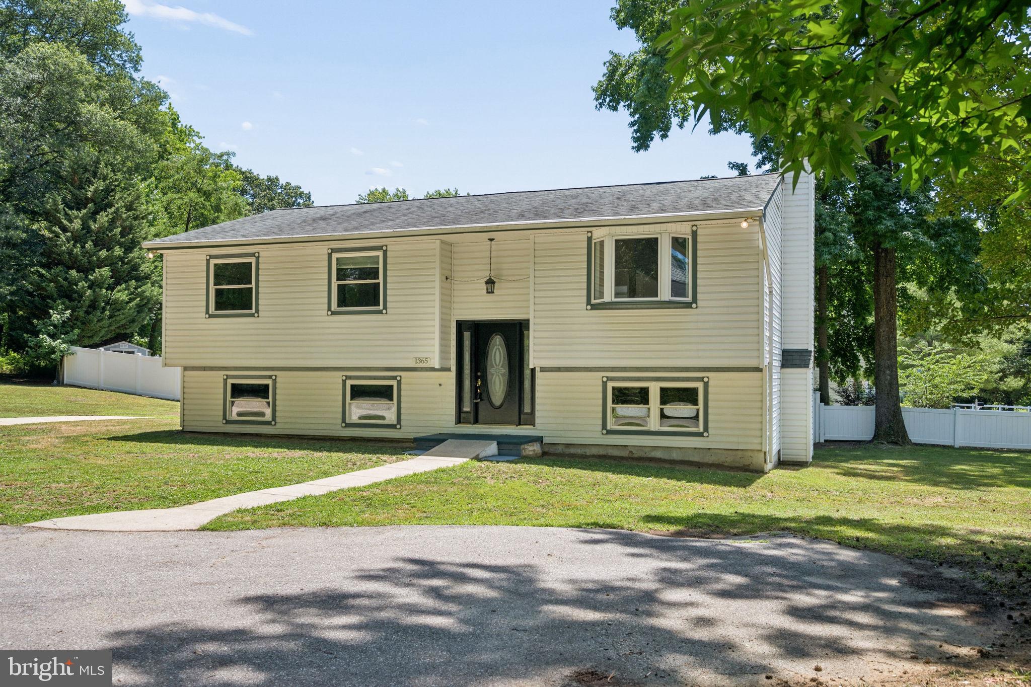 Welcome to 1365 Moyer Road, a beautifully renovated home offering the perfect blend of modern style, privacy, and convenience. Nestled just off Arundel on the Bay Road, this exceptional property is minutes from downtown Annapolis, Quiet Waters Park, and the Chesapeake Bay.
The upper-level features three spacious bedrooms and two fully updated bathrooms, including a serene primary suite complete with an en-suite bath and balcony accessing secluded rear deck. The stunning kitchen showcases luxury finishes, while tastefully updated bathrooms and upscale luxury plank flooring throughout add warmth and sophistication.  Lower-level offers additional rec space with a cozy fireplace, flex room perfect for a home office or playroom and plenty of storage space.
Filled with natural light, the inviting sunroom opens to a brand-new rear deck, creating the ideal space for relaxing or entertaining. Set on a private, fully fenced 0.65-acre lot, this oversized home offers plenty of room to enjoy both indoors and out.
A rare opportunity to own a move-in-ready retreat in an unbeatable location.