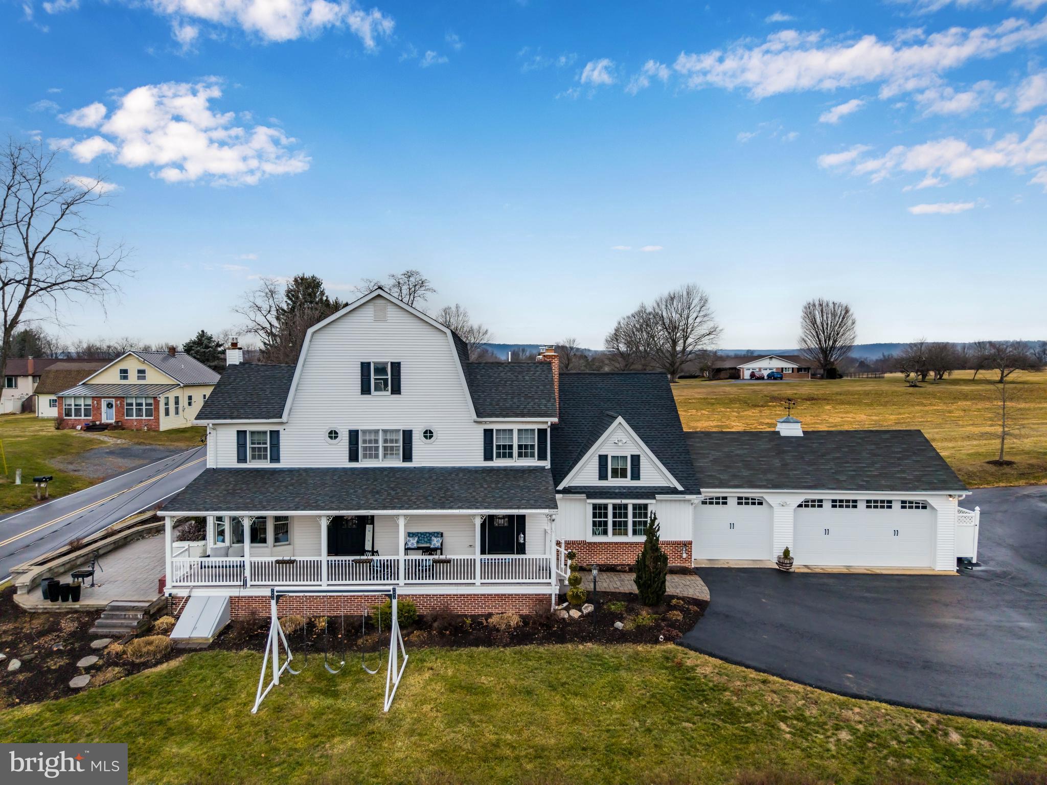 Steeped in history and thoughtfully reimagined, this remarkable farmhouse traces its origins back to 1863, when it served as the original farmhouse on the land. Set on a peaceful 3-acre estate, the home offers a rare and beautiful balance of preserved heritage and modern luxury.

The fully remodeled first floor showcases exceptional craftsmanship and intentional design, highlighted by a custom stone archway, a beautifully redesigned kitchen, and custom bamboo flooring throughout. The kitchen opens seamlessly into a warm and inviting family room, creating an ideal space for everyday living and entertaining. In the private office, exposed wood beams and a mantle harvested from an original smokehouse once located on the property serve as a striking reminder of the home’s agricultural roots. Adding to the historic character, the flagpole and bell date back to 1867, sourced from a nearby property and thoughtfully incorporated into the grounds.

With 6 bedrooms, 4 full bathrooms, and over 5,000 finished square feet, the home offers generous living space designed for comfort, flexibility, and gathering. Upstairs, a beautiful winding staircase leads to spacious bedrooms accompanied by multiple full bathrooms. The primary suite is a true retreat, featuring a large bedroom, sitting area, walk-in closet, and an en-suite bathroom that has been completely remodeled with imported marble tile and an upgraded shower, creating a spa-like experience.

Outside, the land tells its own story. A classic wraparound porch overlooks mature landscaping and open pasture views, while a stone paver patio with an outdoor fireplace provides the perfect setting to relax and take in the surrounding countryside. Under current ownership, the property has supported horses, donkeys, and alpacas, with existing farm infrastructure including a stable, paddock, barn, and greenhouse, making it ideal for those seeking space, privacy, and a true connection to the land.

Multiple garages and ample parking offer everyday convenience, while the combination of history, craftsmanship, and thoughtful updates makes this property truly one of a kind. This is a rare opportunity to own a historic yet highly functional estate where timeless character meets modern living—ready to be cherished for generations to come.