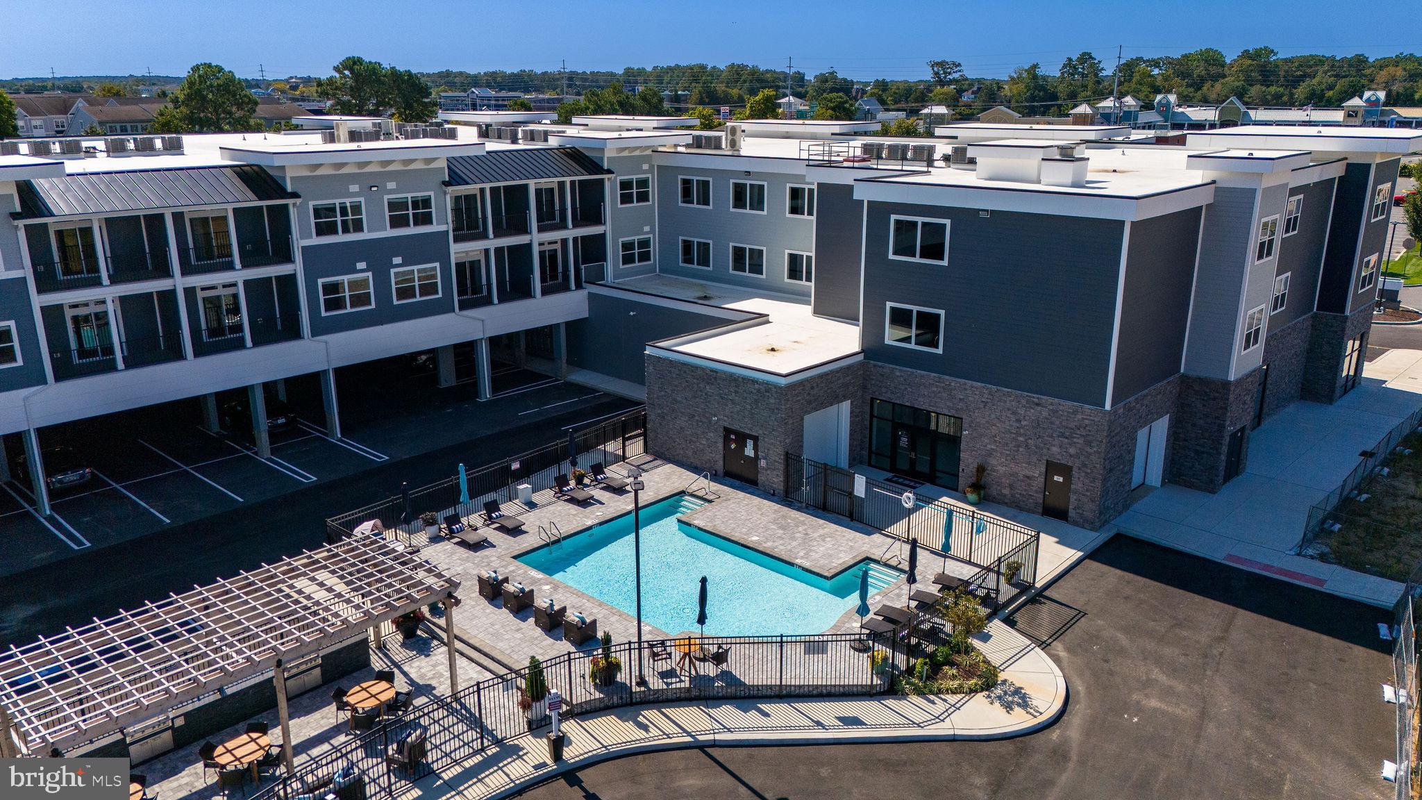 **Photos shown are of furnished sales model with the same floor plan.**Unique and limited opportunity to own one level new construction East of Route 1 in Rehoboth Beach, Delaware. These elegant upscale condos feature Quartz countertops, stainless steel appliances, 42 inch kitchen cabinets, butler's pantry and dry bar, led downlighting, walk in closets, coastal luxury flooring, nine foot ceilings, tile showers with glass enclosure, custom interior molding and doors, full size stacked washer and dryers and private balconies. The community amenities include a beautiful fenced in pool, outside grill, gazebo and firepit, gated covered parking spots, and an enclosed dog run. Residents also have private access to co-working spaces, conference rooms, a beautiful lounge space, a fitness center, a coffee station, storage lockers and a bike storage room. The building has two convenient elevators and common spaces for mail delivery and trash pick up.  Sales center on site daily 10:00 am - 4:00 pm, appointments encouraged.  The community is located within a quick walk or bike ride to the outlet center and Breakwater bike trails as well as a quick car ride to the beautiful coastal beaches and State Parks of both Rehoboth and Lewes. Unit 210 is the Retreat Floor Plan. Low property taxes - only $1272.28 annually. Limited time incentives - inquire for details.