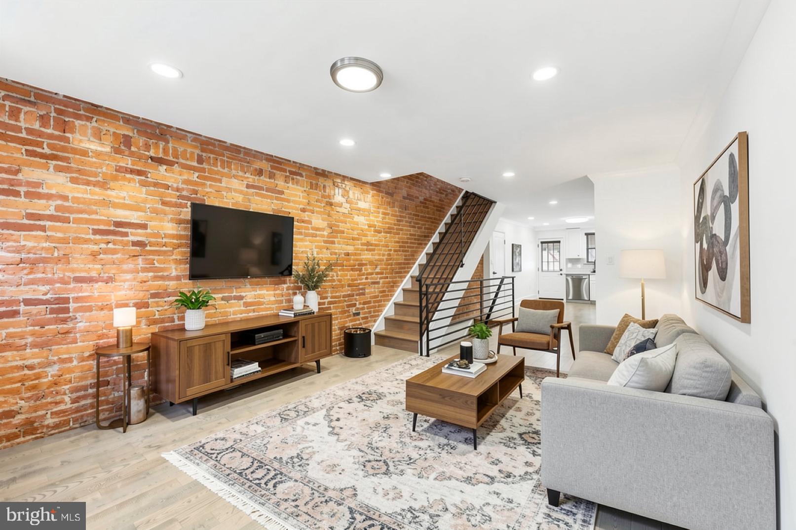 This beautifully maintained 2-bedroom home is now available in the highly desirable East Passyunk Crossing area. The interior features a striking accent brick wall and an open-concept layout, where a spacious living room flows into a modern kitchen designed for both style and functionality. This stunning townhome includes a full bathroom equipped with a soaking tub, a large stand-up shower, and a double vanity; along with a conveniently located half-bathroom on the first floor. On the second floor, the main bedroom serves as a bright sanctuary featuring a new ceiling fan, a spacious closet, and two windows that flood the space with natural light. Adjacent to this is a versatile second bedroom, which works well as a home office, home gym, nursery or extra bedroom. For additional space, the property includes a partially finished basement with a washer and dryer, as well as a private back patio that provides a quiet retreat for relaxation or entertaining. Conveniently located in one of the city's most vibrant neighborhoods, 1632 S Clarion is only steps away from everything you need. This location is ideally situated close to the Tasker-Morris BSL station and multiple bus routes, offering easy access to local transportation. East Passyunk Crossing, known for its incredible food scene, small-town community feel and exceptional walkability, makes this home the perfect place to call your own!