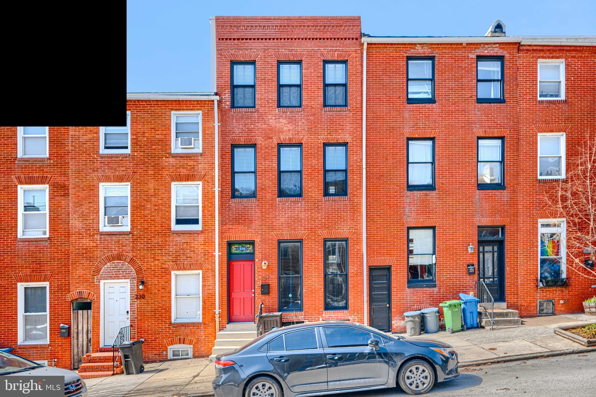 Buyer was unable to lock in financing!  Back on the market with so much to love!  Looking for more space, both indoors and out?  Need 3 actual upstairs bedrooms?  This classic brick-front home in a premier location has it, plus all the modern conveniences you need, combined with the historic charm you love! This 4-level home with over 2,500 sqare feet of living space was fully gut-renovated and designed by Chance Development in 2015 and has been further enhanced and impeccably maintained by the current owner. The double-door entry welcomes you into a spacious living room with charming architectural details, including a beautiful curved staircase, a tray ceiling, crown molding, and wood floors. The living room flows into the open dining and kitchen areas and provides a great setting for entertaining a crowd or for quiet al fresco dinners, as it connects to a private, fully fenced rear patio and yard. The main level of this smartly designed home features a conveniently located powder room, a coveted coat closet, and a bright and updated kitchen with stainless steel appliances, upgraded countertops, and a breakfast bar. On the upper levels, you will find 3 spacious bedrooms, each with large closets and its own full bathroom, a wet bar with wine storage and a beverage refrigerator, and convenient hallway access to a rooftop terrace with sweeping downtown skyline, sunset, and water views! The primary suite includes double closets, one of which is a walk-in, and a gorgeous en-suite marble bathroom with a double sink vanity and a separate custom shower. The spacious laundry room with built-ins and a bonus storage closet is also conveniently located on the home's bedroom level. The lower level has full-height ceilings and offers even more space to enjoy, with a full bathroom and an additional finished room that could be used as a 4th bedroom, den, office, home gym, or another entertaining space… the possibilities are endless! This home sits on a charming tree-lined street at the crossroads of Butchers Hill, Canton, and Fells Point, is close to Johns Hopkins, great local shops, dining, and nightlife, and is just blocks to the beautiful green spaces of Patterson Park and to the waterfront. Come check out this beautiful, unique historic home & fall in love! Rent an off-site garage parking spot just down the street at 307 S Washington St *