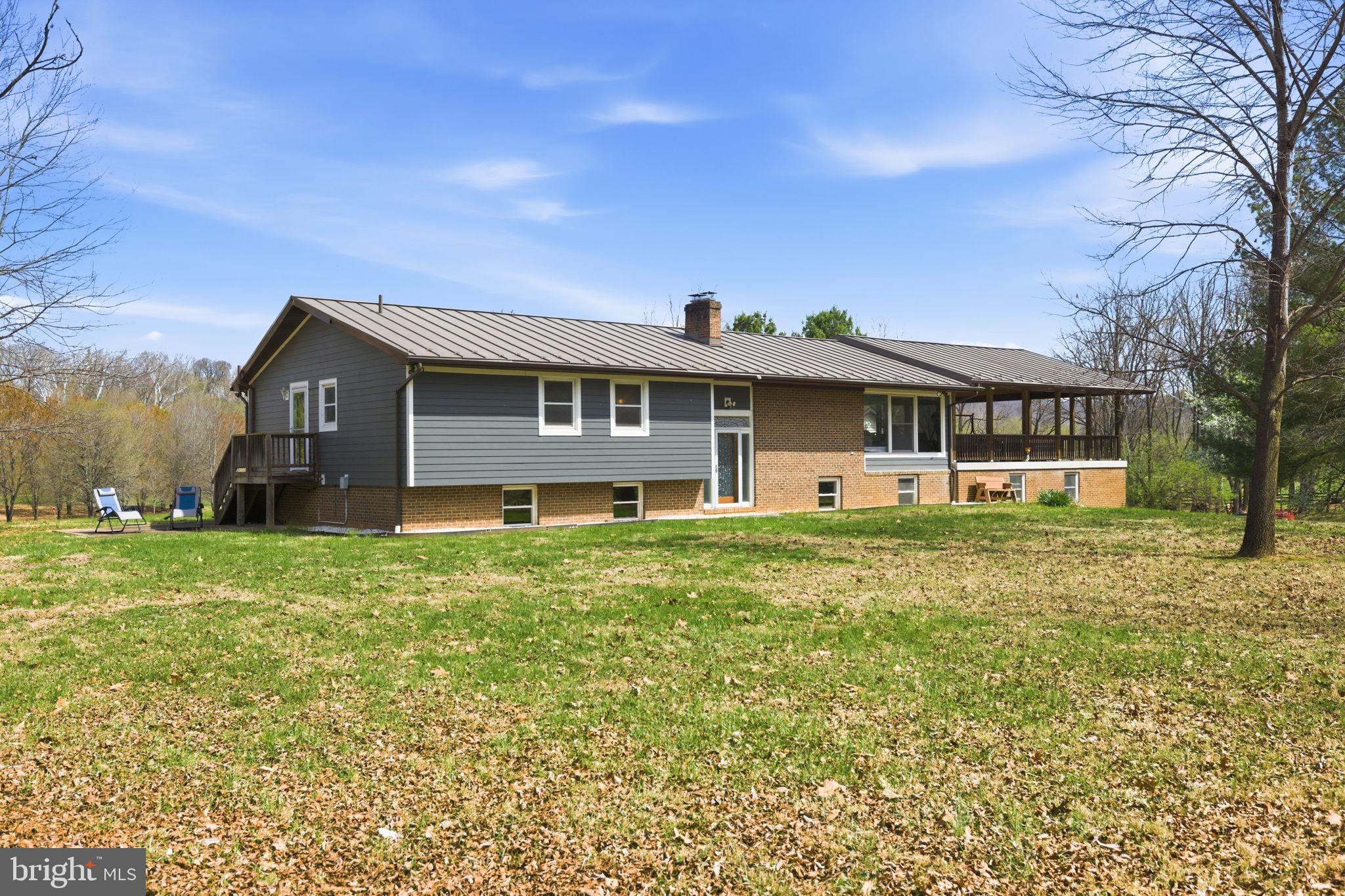 Discover the ultimate riverfront lifestyle at 1527 Shenandoah River Lane in Boyce, VA—where nature, privacy, and comfort come together in perfect harmony. With 320 feet of private waterfront along the scenic Shenandoah River, this property offers a rare opportunity to truly live on the water. Imagine kayaking at sunrise, fishing at sunset, or unwinding to the soothing sounds of the river—this is everyday life here. The level, usable acreage is framed by two wooded areas, creating a sense of seclusion while offering peaceful walking trails and a deep connection to nature. Outdoor living shines with an impressive 32’ x 32’ covered deck —an ideal setting for morning coffee, evening gatherings, or simply taking in the serene, ever-changing views. The home offers over 4,000 square feet of finished living space with 5 bedrooms and 3 full baths. Designed for both comfort and flexibility, the home includes a spacious game room, fully equipped home gym, dedicated office area, and workshop space. At the heart of the home, a cozy wood-burning fireplace anchors the expansive living room, creating a warm and inviting space to gather and relax. The formal dining room sets the stage for holidays and special celebrations. The kitchen features stainless steel appliances, offering both style and everyday functionality. The primary suite is a peaceful retreat, complete with a custom walk-in closet, en-suite bath and private patio ready for your future hot tub. Gardening enthusiasts will appreciate the large fenced garden with raised beds and 9-foot fencing, a 16’ x 24’ shed with electricity, and a 1000-gallon rain barrel—perfect for those who enjoy sustainable living and cultivating their own space. The detached garage is insulated and heated, ideal for large equipment, and includes a 275-gallon diesel fuel tank with meter, nozzle, and indoor shutoff. Modern conveniences are seamlessly integrated, including high-speed internet and a backup generator servicing essential areas of the home, ensuring year-round comfort and peace of mind. Located within the Shenandoah Farms community, residents enjoy access to amenities including a ball field, Shenandoah River recreation lots, Spring Lake, and Lake of the Clouds. Ideally situated just 20 minutes from Winchester, Front Royal, and Middleburg, this property offers the perfect balance of peaceful riverfront living with convenient access to shopping, dining, and commuter routes. If you’ve been dreaming of a home where the river becomes part of your everyday life, this is it.
