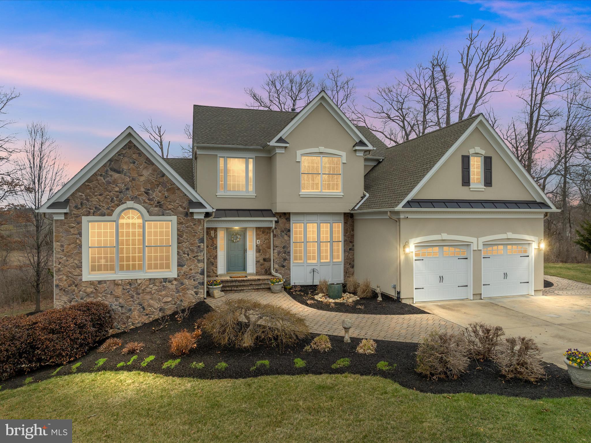 Discover this stunning 5-bedroom, 4.5-bathroom colonial backing to serene wetlands, offering privacy and luxury just minutes from city conveniences. The main-floor primary suite has a large shower and dual vanities, along with a large walk-in closet. The primary bedroom overlooks the private backyard. The family room is accessible from the gourmet kitchen that features quartz countertops, a large island, a wall oven,  walk-in pantry, custom designed cabinetry and hardware, lighting, top end appliances. The family room has a built-in entertainment center, coffered ceilings and a lovely gas fireplace - perfect for cool spring evenings.  The mudroom also has custom built cabinetry with storage for anything you would need, it connects to a well laid out laundry room w/sink. The upper level features 3 bedrooms, all accessible to a bath. 3/4" white oak hardwoods have been installed on both main and upper levels. This home exudes warmth and character while displaying high quality finishings throughout. 

Enjoy indoor-outdoor living with a three-season sunroom and spectacular stone patios featuring a waterfall, fireplace, outdoor kitchen, and bubbler pots.  Modern updates include dual-zone HVAC (7/18 & 6/20) and a new architectural roof (11/23) and a new hot water heater (12/24). There is also a whole house generator.

This home comes with an extra building lot, for a total acreage of 1.78 in the city! It's a rare find.  The home is on city water, but there is a well installed that services the irrigation system, so no large water bills in the summertime from watering! This home is sure to please the outdoor entertainers with the multi-tiered patio and gorgeous waterfall and fireplace as a backdrop for all the get togethers, or just the quiet times overlooking the wetlands from your backyard oasis.  Breathtaking landscaping, this home is a true retreat inside city limits. Don't miss this rare opportunity—schedule your tour today!