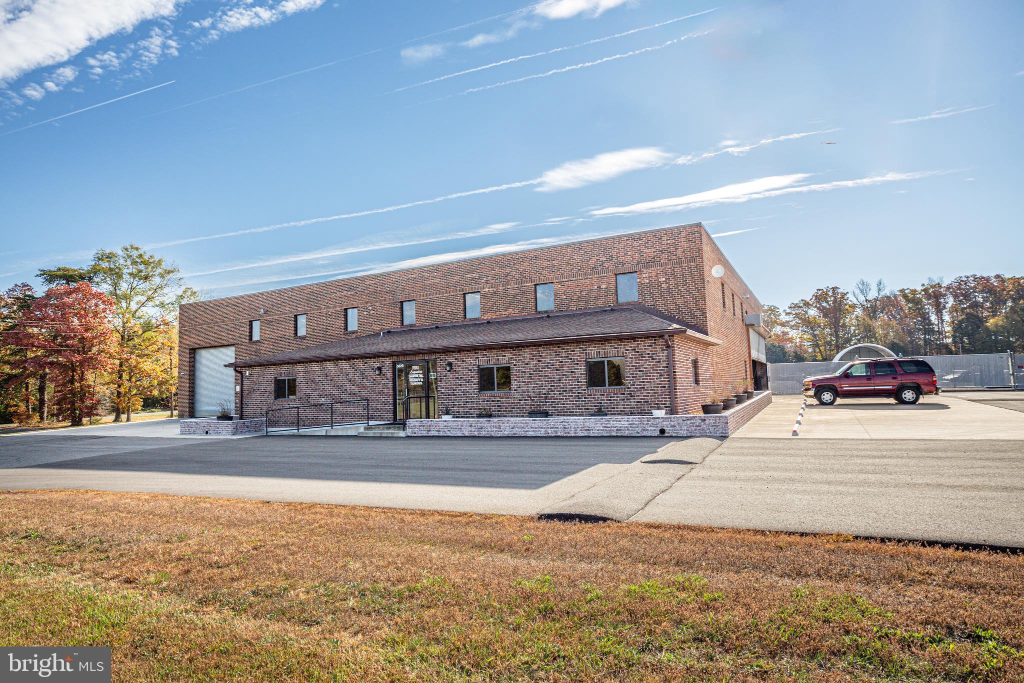You won't find a better location or quality of property in Fauquier County. Located right next to the Warrenton Airport, this  10,752 sqft, 5-acre property is zone for I2 - perfect for light manufacturing, storage, last mile distribution. 
2023 updates include new sliding gate, two (2) ADA compliant warehouse bathrooms, warehouse office. 
2022 updates include 8" concrete pad, parking lot asphalt, new concrete wall at yard, front retaining wall and landscaping, exterior office door.
2016 full office addition added 1300 sqft of modern office with bathroom and access into warehouse, county septic hook up
2014-2015 updates include new roof and gutters, fence, front roll up door
Property also includes two overhead indoor cranes (as-is), 40' wide drive-in door, newer warehouse lighting, 480amp 3 phase electric, truck wash out bay, partial secured parking with lighting.