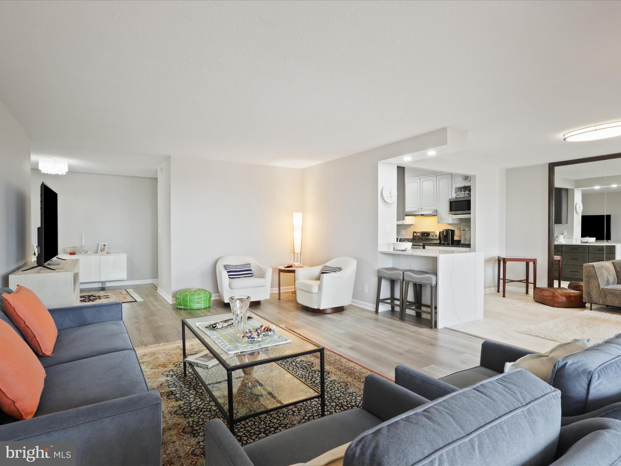 Looking to downsize or move into a beautifully upgraded, move-in-ready home? This is the one! Experience breathtaking, unobstructed EAST and SOUTH views (see listing photos) from this exceptional unit. Enjoy panoramic sights, including July 4th fireworks, Rotonda’s four tennis courts (one converted into a pickleball court), and a tranquil water pond—all visible from your expansive living room windows that will never be blocked. This unit includes two wide, side-by-side garage spaces, each valued at $30K.
You have the option to purchase this property with one garage space for $760,000 or with two garage spaces for $789,999. Upgrades & Features – $73K in improvements since 2021!Kitchen: Partially opened and upgraded with quartz countertops and stainless steel appliances, plus an extra stainless steel freezer in the pantry. Living Area: Enclosed patio converted into additional living space with new modern air vents, new flooring, new doors, and high-end UV-protected window treatments. HVAC: One unit replaced in 2023.Primary Bathroom: Modern, open layout with glass sliding doors and extra closet space. Secondary Bathroom: Features a double-sink vanity for added convenience. Bedrooms: Generously sized with walk-in closets and plenty of natural light. Den/Bedroom: Versatile space with a private patio-perfect as a guest room, media room, or home office. Resort-Style Amenities at Rotonda: Indoor & outdoor pools with a spa. Four lighted tennis courts, including a dedicated pickleball court. State-of-the-art gym. Game and media rooms. Basketball & volleyball courts. Electric car charging stations. Car wash & vacuum facilities.24/7 security for peace of mind. Putting green. Prime Location. Rotonda is just minutes from Whole Foods, top restaurants, Greensboro & Spring Hill Metro stations, and major roadways (267, 495, and Route 7). This stunning, move-in-ready home blends modern design with functional upgrades, making it the perfect fit for your lifestyle. Don’t miss out—schedule your showing today!