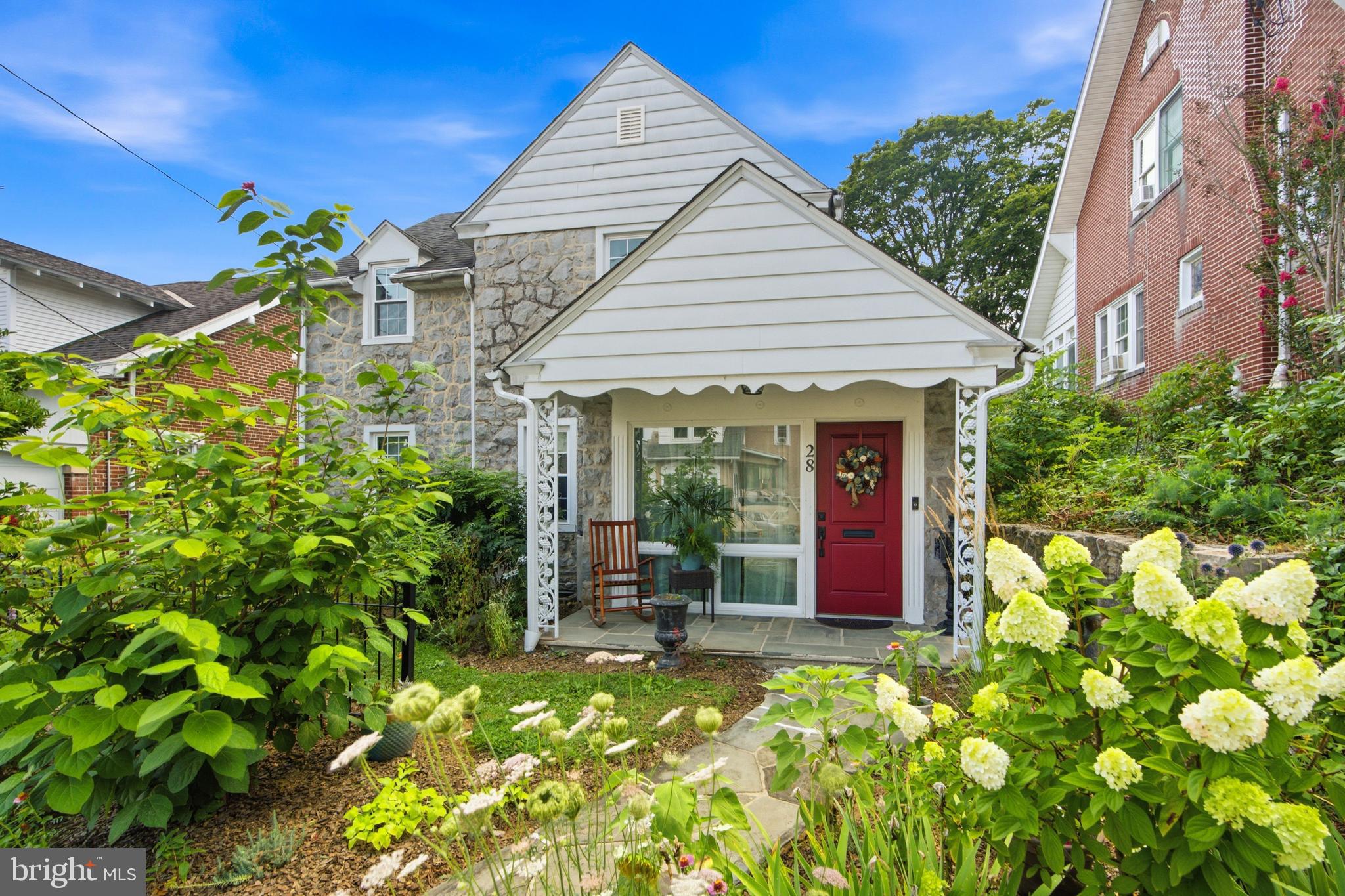 Classic Boyertown Stone Colonial with Gardens, Greenhouse, Local History & Rare Turnkey-Style Inclusions. 

Welcome to 28 W 2nd Street, a charming detached stone Colonial in Boyertown Borough offering 3 bedrooms, 1 full bath, 2 half baths, and approximately 1,882 square feet of above-grade living space. This classic 1910 home blends old-home character, thoughtful seller-disclosed improvements, established gardens, and a rare turnkey-style opportunity with many furnishings and property items included.

The main floor features wood floors, a spacious living room with pellet stove insert, formal dining room, updated kitchen, convenient powder room, den with built-ins, and a rear mudroom/entry area with attractive patterned tile flooring. The kitchen offers stylish cabinetry, attractive countertops, stainless appliances, induction cooking, farmhouse-style sink, and a warm, updated feel.

Upstairs are three bedrooms, including a spacious primary bedroom with hardwood flooring and a wall-mounted mini-split, plus a full bath and an additional half bath. The home also offers public water and sewer, oil hot-water radiator/baseboard heat, and three second-floor wall-mounted mini-split units with heat, A/C, dehumidifier, and fan functions. Additional features include deep window sills, classic trim, and an unfinished basement with walkout stairs.

The exterior offers a charming garden-style setting with mature plantings, flowering perennials, established cutting gardens, greenhouse, porch areas, and included lawn/garden equipment. The gardens are designed to provide seasonal cutting flowers, adding warmth, color, and lifestyle appeal throughout the year.

Seller-disclosed improvements include kitchen and dining renovations, replacement of most windows, mini-splits, pellet stove, radon remediation system, security lighting, attic fan/vents, front fence, greenhouse, updated toilets, hard-wired smoke/carbon monoxide detectors, electrical outlet improvements, 2021 appliances, and more.

 Adding to its Boyertown charm, public record history indicates the home was once owned by Paul R. and Erminie F. Hafer, founders of the Boyertown Museum of Historic Vehicles.

Many furnishings, appliances, greenhouse, lawn/garden equipment, porch furniture, beds, dining furniture, living room furniture, TVs, washer/dryer, and other items are included as detailed in the Property Inclusions Addendum. See Property Inclusions and Exclusions Addenda for complete details. Conveniently located close to Boyertown amenities, shopping, dining, parks, schools, and major routes.