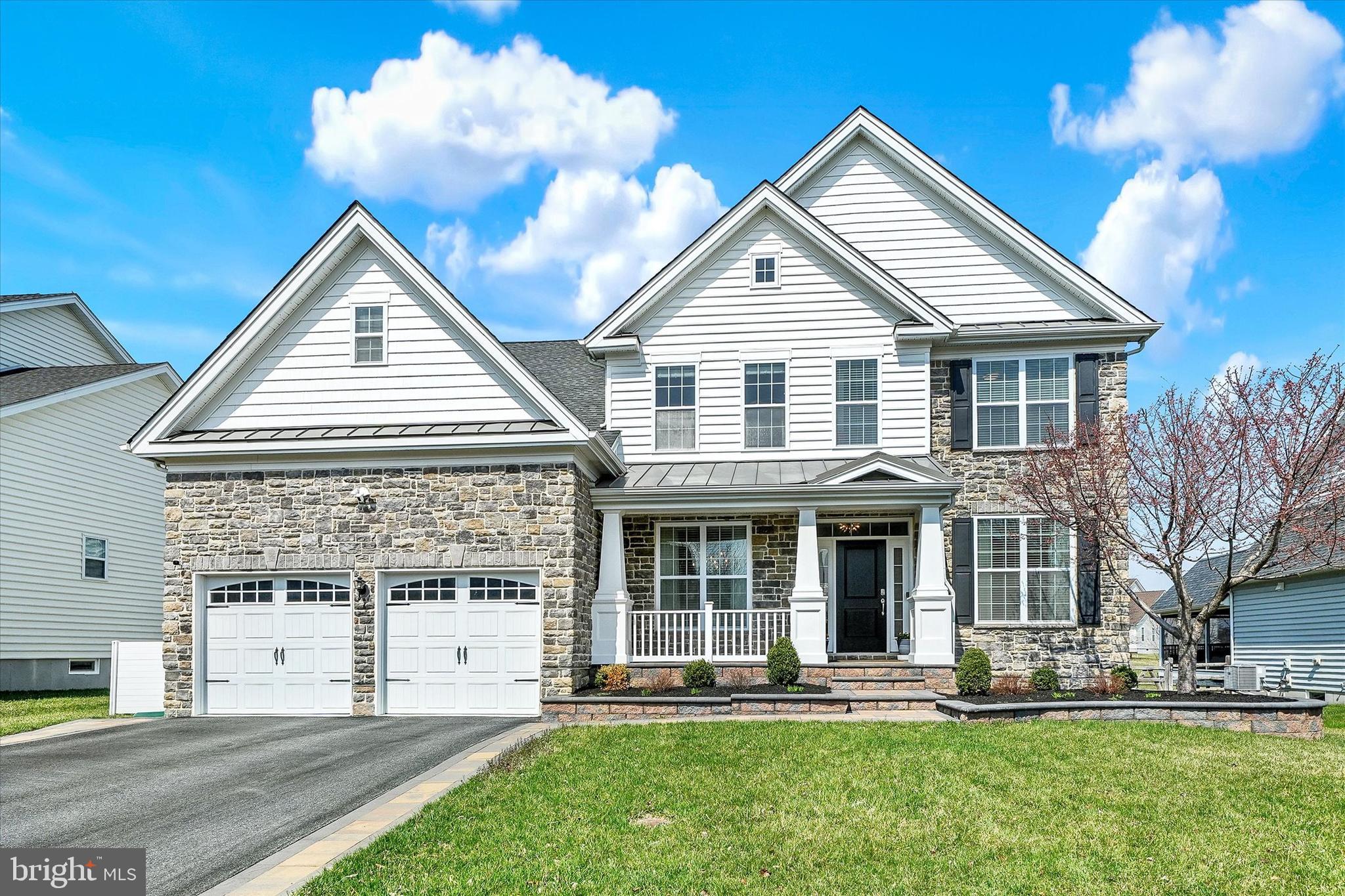 This exceptional, move-in ready Executive home offers over 4,400 square feet of beautifully finished living space, designed for today’s discerning buyer seeking luxury, convenience, and outstanding value. Enjoy upscale suburban living with the added advantage of Delaware’s comparatively low property taxes.
Ideally located in a highly sought-after community with easy access to Route 1 and I-95, this home offers effortless commuting to Wilmington, Philadelphia, and beyond.  It serves as a convenient midpoint between New York City and Washington, D.C. Residents enjoy resort-style amenities including a clubhouse, outdoor pool, fitness center, tot lot, and walking paths, all for a reasonable monthly fee, along with the flexibility of Delaware’s School Choice Program.  The Country Manor elevation impresses upon arrival with a stone-accented façade, carriage-style garage doors, and extensive custom hardscaping, including an expanded paver driveway, lighted entry pillars & walkways leading to a welcoming front porch.
Inside, the classic center hall colonial layout is professionally painted & enhanced with modern finishes. The foyer opens to formal living and dining rooms, while wood flooring spans most of the main level, complemented by 9-foot ceilings for a bright, open feel. A private home office with double doors overlooks the rear yard and is ideal for a remote workplace.  The dramatic two-story family room features a floor-to-ceiling stone fireplace and flows seamlessly into the gourmet kitchen, complete with a center island, granite countertops, tiled backsplash, soft-close cabinetry with glass accents, pantry, and premium KitchenAid appliances. The adjoining sunroom with vaulted ceilings is filled with natural light and opens to the outdoor living spaces.  The rear yard  faces the open space between two houses and is beautifully enhanced by a composite deck and paver patio with built-in seating to relax or enjoy during your parties and barbecues.  A functional mudroom with utility sink and large coat closet connects to the garage, featuring durable epoxy flooring.  Upstairs, an open hallway overlooks the family room below, filled with natural light and expansive views. A bedroom-level laundry room with new washer and dryer adds everyday convenience. Bedroom Two offers a fabulous walk-in closet and shares a well-appointed hall bathroom with Bedrooms 3 and 4.  The Owner’s Suite is a true retreat, featuring a spacious bedroom with double-door entry, a versatile sitting room ideal for a private office or comfortable lounging room, and a luxurious en-suite bath with frameless glass tiled shower, soaking tub, and expansive walk-in closet.
The finished lower level creates generous living spaces with a large recreation room, a versatile finished bonus room, and a full bathroom. Everything you need for extended guests stays, celebrations or simply for you to enjoy.  An unfinished bonus space also with epoxy painted floors provides flexibility for a future home gym or your own customization.  With all this great finished space, there is also plenty of storage room too!  This exquisite executive home seamlessly blends everyday comfort with ideal features for elevated hosting & gatherings  offering the space, style, and location today’s luxury buyers deserve.
Editing has been completed to the photos shown.  All room measurements & square footages listed are estimates and to be verified by Buyer.  Schedule your tour today to see this impressive home!