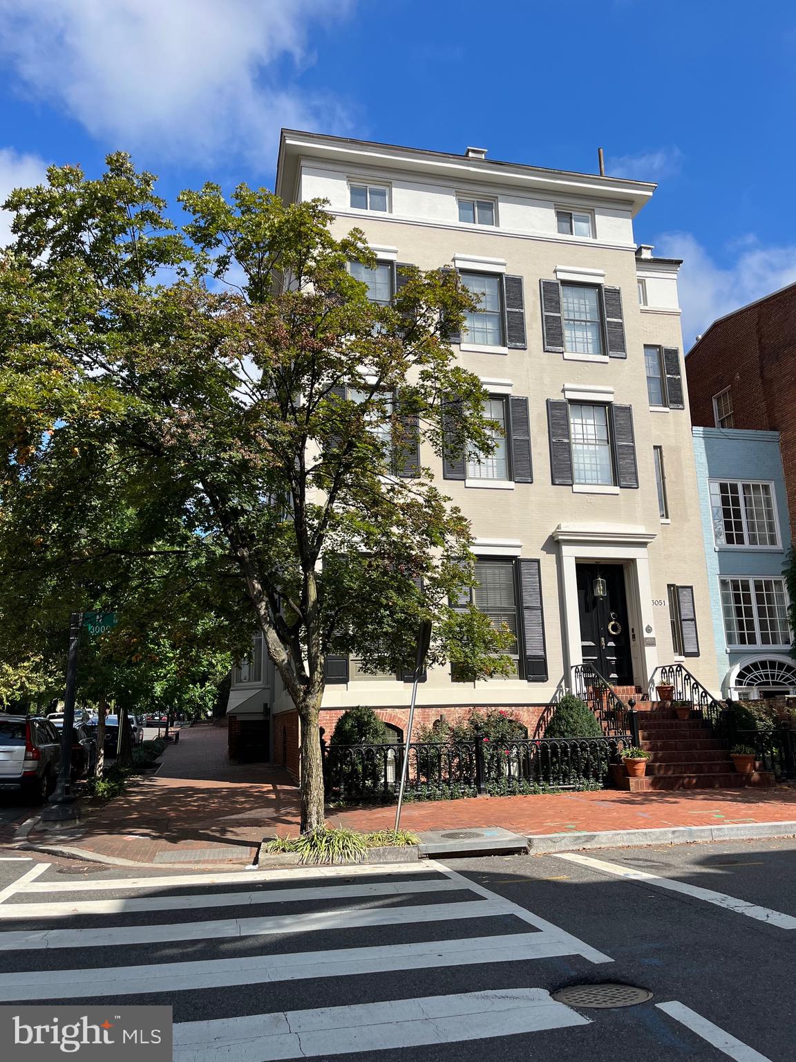 11,000 SF prominent, stately home on the corner of 31st and N St in the East Village of Georgetown. A total of 7 Bedrooms, 6.5 Baths with two-car garage parking. This historic home features a grand foyer, staircase, vestibule, elegant entertaining rooms with 14' ceilings, handsome library with floor-to-ceiling bookshelves, exquisite moldings, marble mantels, 10 fireplaces, sun room, and landscaped patio with pond. The top level boasts unobstructed views of downtown Georgetown, Monuments, Chain Bridge, and the Potomac River. The lower level has a sauna, wine room, bar, rec room, office space, and a full bath. Located on the top floor, is an apartment with a spacious living space, two bedrooms, full kitchen, and separate stairway for privacy - perfect for an au pair.