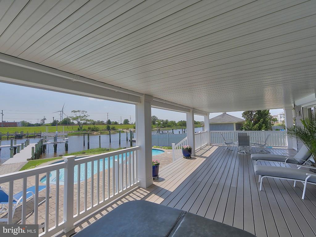 Located on the Rehoboth-Lewes Canal in Lewes Beach, Delaware, this beautiful, 5-bedroom home offers both amazing water views and luxurious living. Features include a newly remodeled kitchen, double oven, wine fridge, multiple balconies, large decks, a spacious open floor plan, high ceilings, large windows with custom remote blinds, hardwood floors, a boat dock and lift with deep water access, an in-ground saltwater pool, a jacuzzi, a security system,  partially fenced yard and an elevator. First-floor features include a 2-car garage with ample storage, a kitchenette, 2 bedrooms, and a full bathroom. Second floor offers a master suite, two bedrooms, one bath, a spacious laundry room, a kitchen, and open living space. Third floor features a bar area. Your roof top deck offers 360 views of the canal and Lewes Beach. This gorgeous property is only steps to both the Lewes Yacht Club and Roosevelt Inlet, and is owned fee simple.
