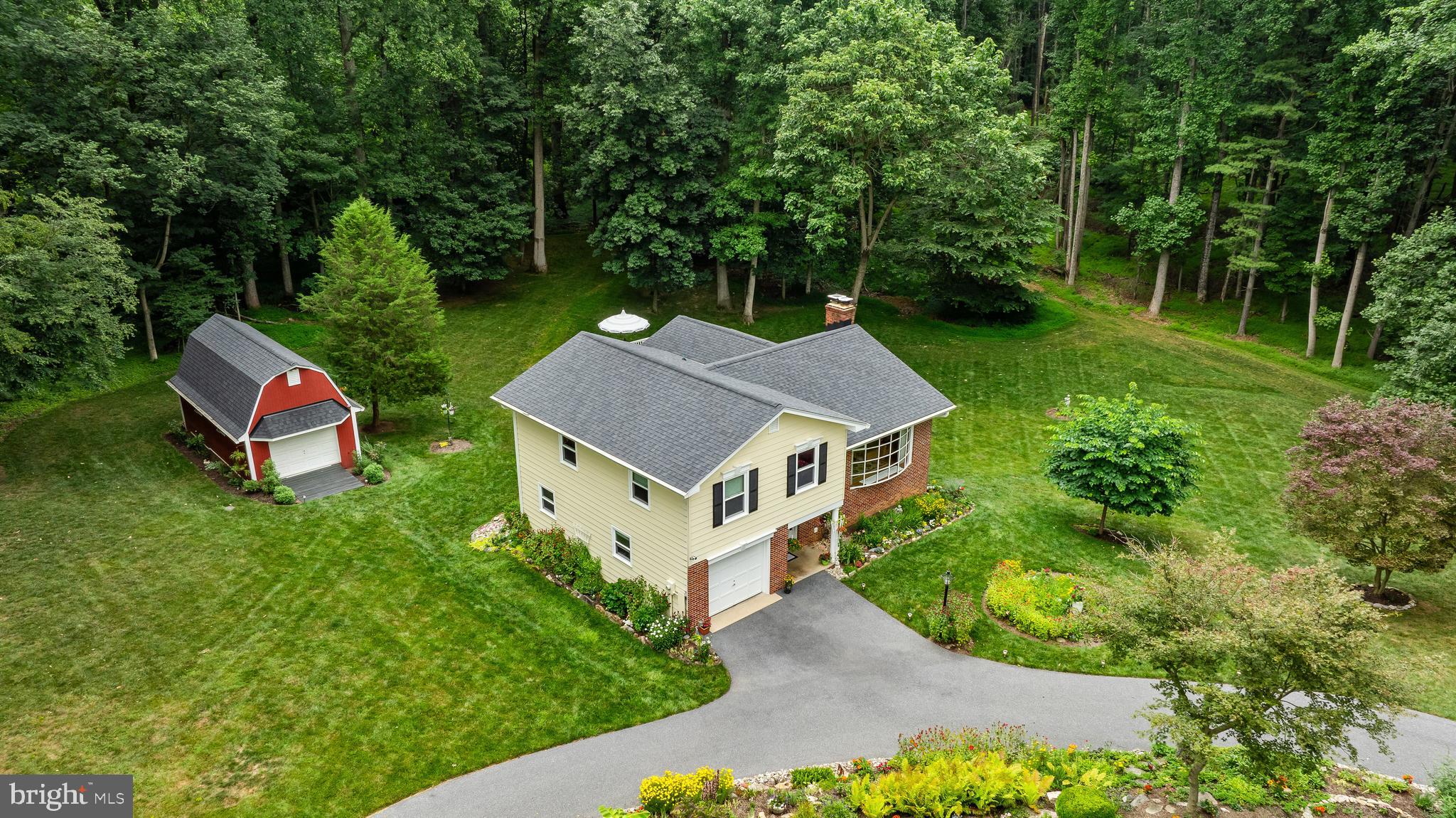 Welcome to this rare opportunity to own a special home on an amazing piece of property in Eldersburg—offering privacy, space, and timeless charm on a beautifully situated 1.36-acre lot. Lovingly and meticulously maintained by the same family since 1969, this home reflects over five decades of pride in ownership and thoughtful care. Perfectly positioned adjacent to the Liberty Reservoir watershed, this property lies right next to thousands of acres of permanently protected forest and open space. The Liberty Reservoir watershed encompasses approximately 46,000 acres of preserved land, managed to protect and maintain one of the region’s most pristine natural environments. This unique setting offers unmatched access to outdoor recreation, including miles of hiking trails, fishing, boating, hunting opportunities, and abundant wildlife—all just outside your doorstep. The home itself is surrounded by beautifully maintained flower beds and mature landscaping, creating a warm and inviting first impression. Outdoor living is exceptional, featuring a screened porch and expansive deck that overlook serene, private wooded views—an ideal setting for morning coffee, evening gatherings, or simply enjoying the quiet rhythm of nature. Inside, the home offers 4 bedrooms and 1 full and 1 half bath with a flexible, well-designed layout. The main level features bright and comfortable living spaces, including a welcoming living room with a floor to ceiling window that brings the beauty of the outdoors into your living space, a dedicated dining area, and a functional kitchen designed for everyday living and entertaining. The upper level includes three spacious bedrooms, while the lower level provides an additional bedroom, a finished recreation area, unfinished storage and walkout access—perfect for guests, home office space, or extended living arrangements. Additional features include, a one-car attached garage, a large shed providing for abundant storage and room for yard equipment and a workshop. A private well and New septic system (2025), Roof replaced (2020), Deck and screened porch (2023) and ample driveway parking. A truly special offering where long-term stewardship, natural beauty, and direct access to one of Maryland’s most significant protected watersheds come together in one remarkable property—just minutes from commuter routes, Carroll County schools, and all the conveniences of Sykesville and Eldersburg.