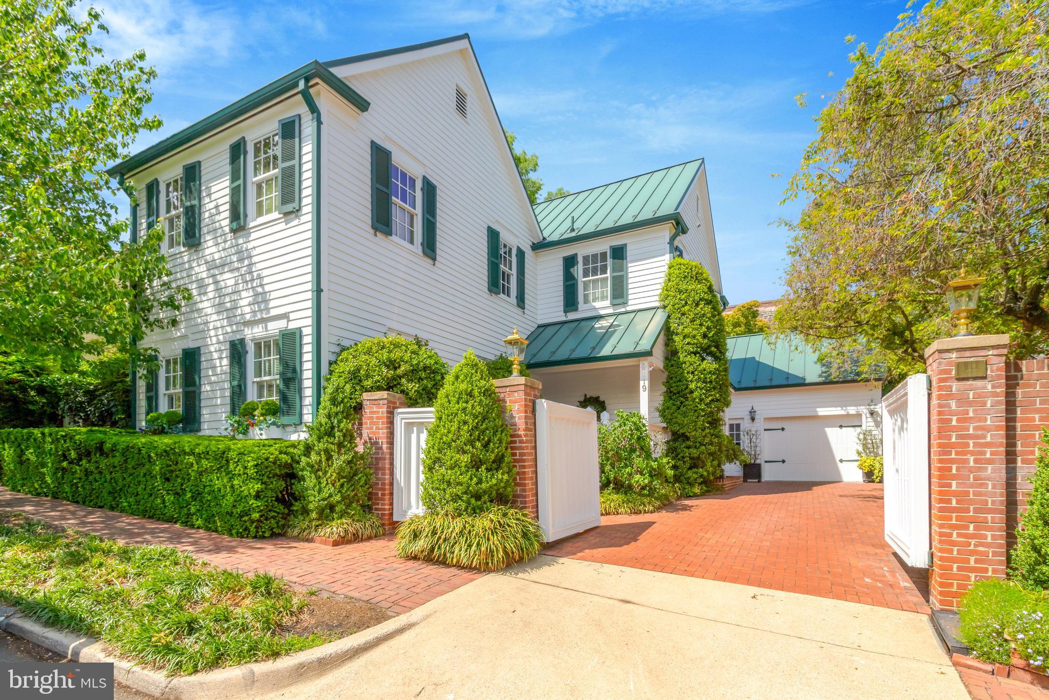 Welcome to 119 Wolfe Street, a distinguished residence located in the heart of Old Town Alexandria, Virginia. This exceptional property offers the rare combination of ultimate privacy and proximity to the scenic Potomac River, just one block away. Spanning 5,884 square feet, this fully detached home is a unique find in Old Town, boasting a gated driveway and garage—an uncommon convenience in this historic area.  Upon entering, you are greeted by a spacious foyer with a large coat closet, setting the tone for the elegant yet comfortable atmosphere that permeates the home. The main level features a great circular flow, ideal for both entertaining and everyday living. The grand dining room includes a charming window seat, adding a touch of character to the home. The updated kitchen is equipped full-size separate Sub-Zero refrigerator and freezer, double ovens, and quartz counters. The breakfast area features a wall of windows overlooking the beautifully landscaped back garden, providing an abundance of natural light.  This residence comprises six generously sized bedrooms and six bathrooms, including four full and two half baths. The primary bedroom offers access to a spectacular roof deck with a new roof and decking. An elevator services all three levels of the home, ensuring ease of movement throughout.  The lower level is fully finished and includes a spacious guest suite with a cozy built-in bed, offering comfort and privacy for visitors. Additional amenities include three fireplaces, enhancing the warmth and ambiance of the home. The scullery or butler's pantry off the kitchen is a luxurious space, ideal for culinary enthusiasts.  Outdoor living is equally impressive, with a serene patio featuring a built-in gas grill, perfect for alfresco dining and entertaining. The gorgeous garden provides a tranquil retreat, while the covered front porch entry welcomes you home.  This property is not historic, yet it embodies the charm and elegance associated with Old Town Alexandria. Its unique attributes, such as the gated driveway and garage, make it a rare offering in this sought-after neighborhood. With its prime location, exceptional privacy, and luxurious amenities, 119 Wolfe Street is a remarkable opportunity for discerning buyers seeking a sophisticated lifestyle in a vibrant community.  Explore the possibilities of owning this exquisite home, where elegance meets comfort in one of Alexandria's most desirable locations.