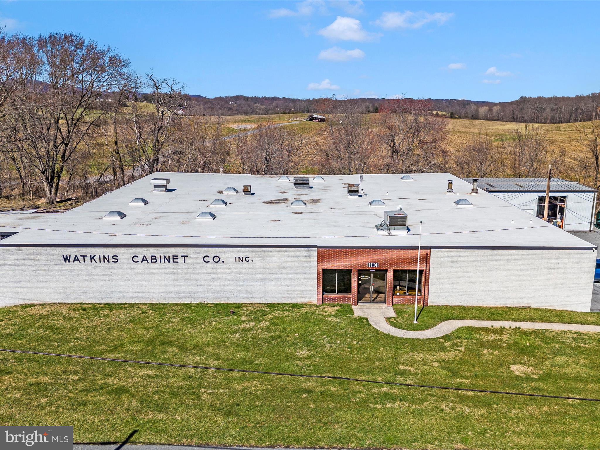 Watkins Cabinet Company Warehouse for Sale – This sale includes the Fee Simple Interest of the 14,884 sq. ft. one-level industrial/manufacturing building, situated on 62,291 sq. ft. (1.43 acres) of land, zoned IM-2.5 H-50 and Ag Reserve. The sale also includes the adjoining unimproved 22,093 sq. ft. (.51 acres) parcel (Parcel Number: P097) with similar zoning. All showings must be accompanied by the local listing agent. All prospective purchasers must provide a proof of funds or loan qualification letter to the listing agent prior to scheduling a showing. Seller financing is available for qualified buyers.  This sale represents a once-in-a-lifetime opportunity; interested parties should act accordingly.