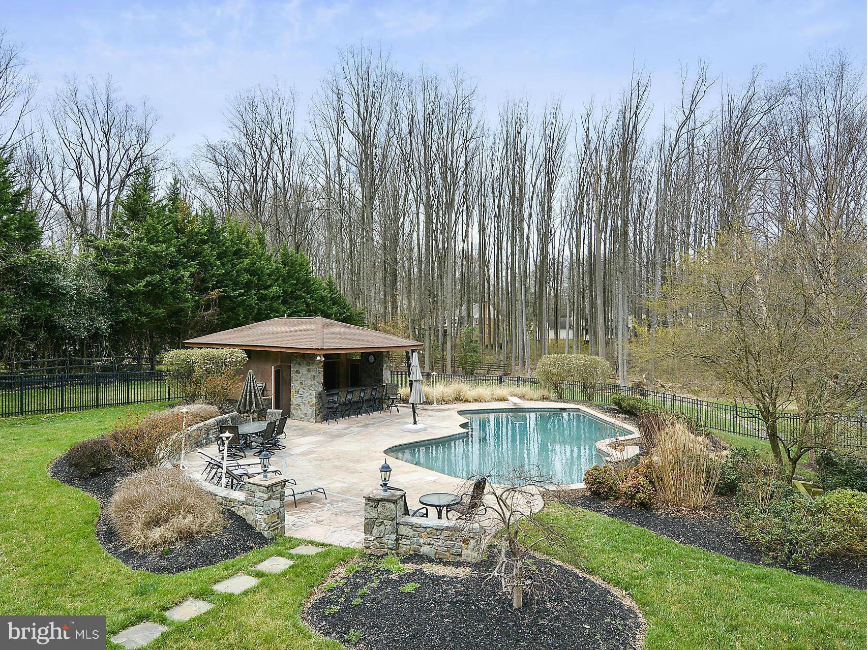 The Pool is Open! Over 1 acre of land sets this house apart. Entertainer's dream; amazing backyard; pool & pool house w/full bath; ironwood deck & irrigation system. 38' addition on 2 levels; renovated gourmet kitchen; new carpet throughout; marble master bath w/steam shower & heated floors. Finished lower level w/full bath, 2 large recreation areas & exercise room. New 50-yr architectural roof. M