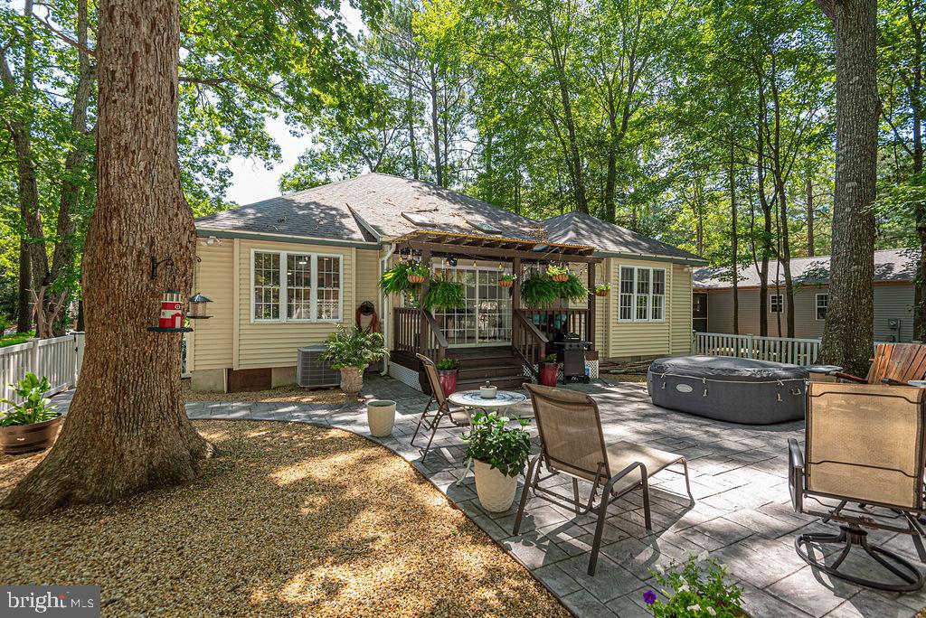 This stunning ranch-style home, set on a beautifully landscaped lot, offers a harmonious blend of luxury and comfort. The interior boasts over 1,500 sq. ft. of thoughtfully designed space, featuring three bedrooms and two full bathrooms. The front bedrooms are  perfect for guests or as a private office. The heart of the home is the expansive kitchen, complete with an island, stainless steel appliances, and a cozy breakfast bar, seamlessly flowing into the dining area adorned with crown moldings and recessed lighting. Major renovations in 2024 have elevated this residence, including new roof, interior paint, doors, fixtures, lighting, and appliances.  Enjoy the warmth of the electric fireplace in the living area, enhanced by abundant natural light from skylights and insulated windows. The primary suite features a double door entry, tray ceiling, walk-in closet and a spa-like bathroom with a walk-in shower, lighted faucets, and shiplap walls/ceiling.  From the light-filled sunroom, step outside to discover a covered porch, fire pit, extensive hardscaping, pea gravel, a hot tub, and multiple patios perfect for entertaining or relaxing amidst the serene backdrop of trees, vinyl fencing, and gardens. The community offers an array of amenities, including pools, tennis courts, and walking paths, fostering an active lifestyle. Located in a vibrant neighborhood within walking distance to popular restaurants, bars and conveniences.  With easy access to recreational facilities and a welcoming community atmosphere, this property is a true gem for those seeking a blend of luxury and lifestyle.