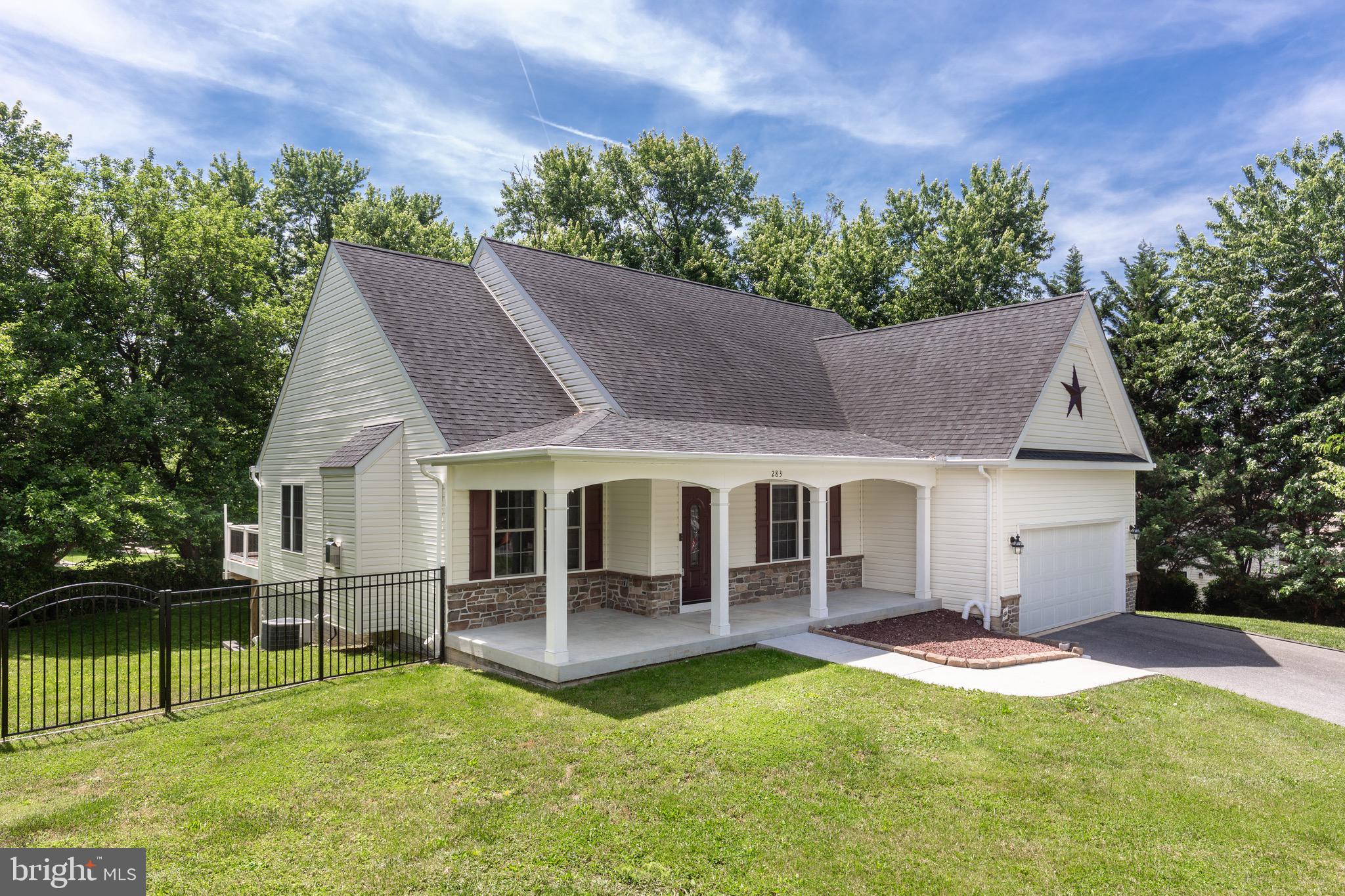 This charming rancher at 283 Maring Drive offers the perfect blend of comfort, style, and functionality, with 3 bedrooms, 2 full bathrooms, a 2-car garage, and a circular driveway, all nestled on a quiet private drive with a beautiful lot and fenced backyard. From the moment you step inside, you’ll appreciate the spacious, open-concept main level featuring hardwood flooring and a light-filled family room with a vaulted ceiling and striking stone gas fireplace, creating a warm and inviting centerpiece for the home. The kitchen is designed for both everyday living and entertaining, complete with granite countertops, pendant and recessed lighting, a center island, pantry, cherry cabinets, gas cooking, stainless steel appliances, and a dining area that opens seamlessly to the deck for easy indoor-outdoor enjoyment. The primary suite offers a relaxing retreat with a tray ceiling, walk-in closet, and a private bath featuring a soaking tub, separate shower, and double sinks, while the second bedroom also includes a walk-in closet. The partially framed basement adds even more potential, with 9-foot ceilings, full-size windows, and a ground-level walkout just waiting to be transformed into additional living space.