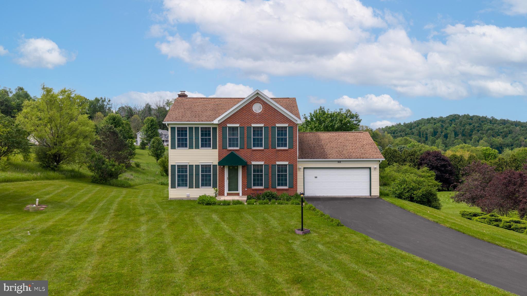 Welcome home to your charming oasis! Enjoy breathtaking views of the countryside and rolling mountains from this beautiful two-story home set on over an acre in the SCASD. This meticulously maintained residence boasts stunning hardwood floors throughout the main level. The inviting eat-in kitchen features granite countertops, while the bright living room, elegant dining room, and cozy family room with a wood-burning fireplace create the perfect spaces for relaxation and entertaining. The main level also includes a wonderful all-season room with panoramic views, a convenient powder room, and easy access to the oversized two-car garage. Upstairs, the owner's suite offers a spacious bedroom, two large walk-in closets, and a private full bath. Two additional well-appointed bedrooms, each with generous walk-in closets, and another full bath complete the upper level. The walkout, partially finished lower level, provides a fantastic rec room with a built-in craft area and ample closet space. Step outside to a covered patio and a beautifully manicured backyard featuring a serene nature area and storage shed. Modern geothermal heating and cooling, solar panels, and so much more add exceptional value to this impressive home.
