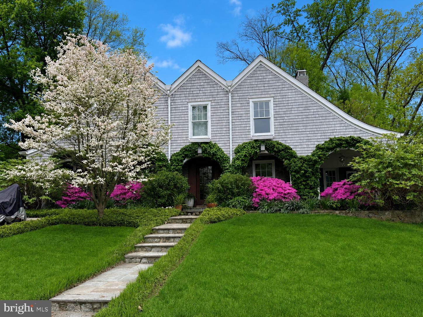 New England Meets Chevy Chase
Hands down—this one is truly special. Set on an extra-wide over 11,000 square foot lot, the property offers a rare combination of thoughtful design and inviting outdoor space, from the fenced play area and lush lawn to the charming treehouse, stone patio, vegetable beds, and tranquil pond with waterfall. Completely rebuilt and custom designed in 2012, this architectural gem draws inspiration from the New England coastline and beautifully brings the outdoors in.
An expansive covered front porch sets the tone, with two distinct seating areas including one with retractable screens, ceiling fans, and a porch swing—an ideal place to relax and unwind. The rear terrace and landscaped backyard create a seamless extension of the home, perfect for both quiet enjoyment and entertaining. For nature lovers, the proximity to Rock Creek Park—just a few blocks away—is the finishing touch.
Inside, the craftsmanship is exceptional, with custom solid cherry wood throughout. The heart of the home is a true chef’s kitchen, featuring heated floors, a gas fireplace, dual ovens, a large walk-in pantry, and beautifully crafted cabinetry. An eating nook makes this space as functional as it is welcoming. The living room, centered around a glass-front wood stove, features direct views of the koi pond, waterfall, and gardens through a wall-sized floor-to-ceiling window. The living room further opens to a cozy main-level library with a built-in desk. A formal dining room and a well-placed powder room complete the main level.
Upstairs, four bedrooms offer comfort and flexibility, all with marble bathrooms and generous, walk-in closets. The primary suite is a standout, with dual showers including a rain head, a double vanity, air tub, and a spacious walk-in closet.
The lower level is designed for both relaxation and versatility, featuring a rec room with a third fireplace, a bonus room ideal for guests or a home office, full bath, and a finished laundry room with additional storage.
Outdoors, the backyard is a true gardener’s paradise, with thoughtfully designed flower beds designed around a koi pond with waterfall, a dedicated vegetable garden, built-in gas grill, and a large shed tucked discreetly into the corner. Every detail has been considered, creating a home that feels both elevated and effortlessly livable.  See why this home was scouted by "HGTV Copy that Curb Appeal!"