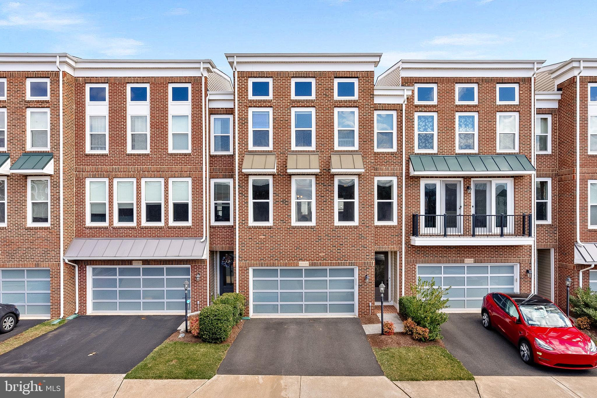 This stunning 4-bedroom, 3.5-bathroom townhouse in Brambleton offers over 3,200 square feet of luxurious living space. The main level features a gourmet kitchen with stainless steel appliances, a dining room, a living room, and an additional sitting area. Upstairs, the primary bedroom boasts walk-in closets and a luxury en-suite bath, along with two additional bedrooms, a full bath, and a laundry room. The lower level includes a spacious recreation room, a fourth bedroom, a full bath, and walk-out access to a fenced backyard. Residents of the Brambleton Community Association enjoy exceptional amenities, including multiple swimming pools, play areas, extensive trails, tennis courts, ball fields, parks, and a community center with a fitness facility. Just minutes away, Brambleton Town Center offers grocery stores, banking services, medical facilities, dining options like Blue Ridge Grill and AhSo Restaurant, retail shops, and entertainment venues. With convenient access to major commuter routes such as the Dulles Greenway and Loudoun County Parkway, this home provides the perfect blend of luxury, community, and accessibility.