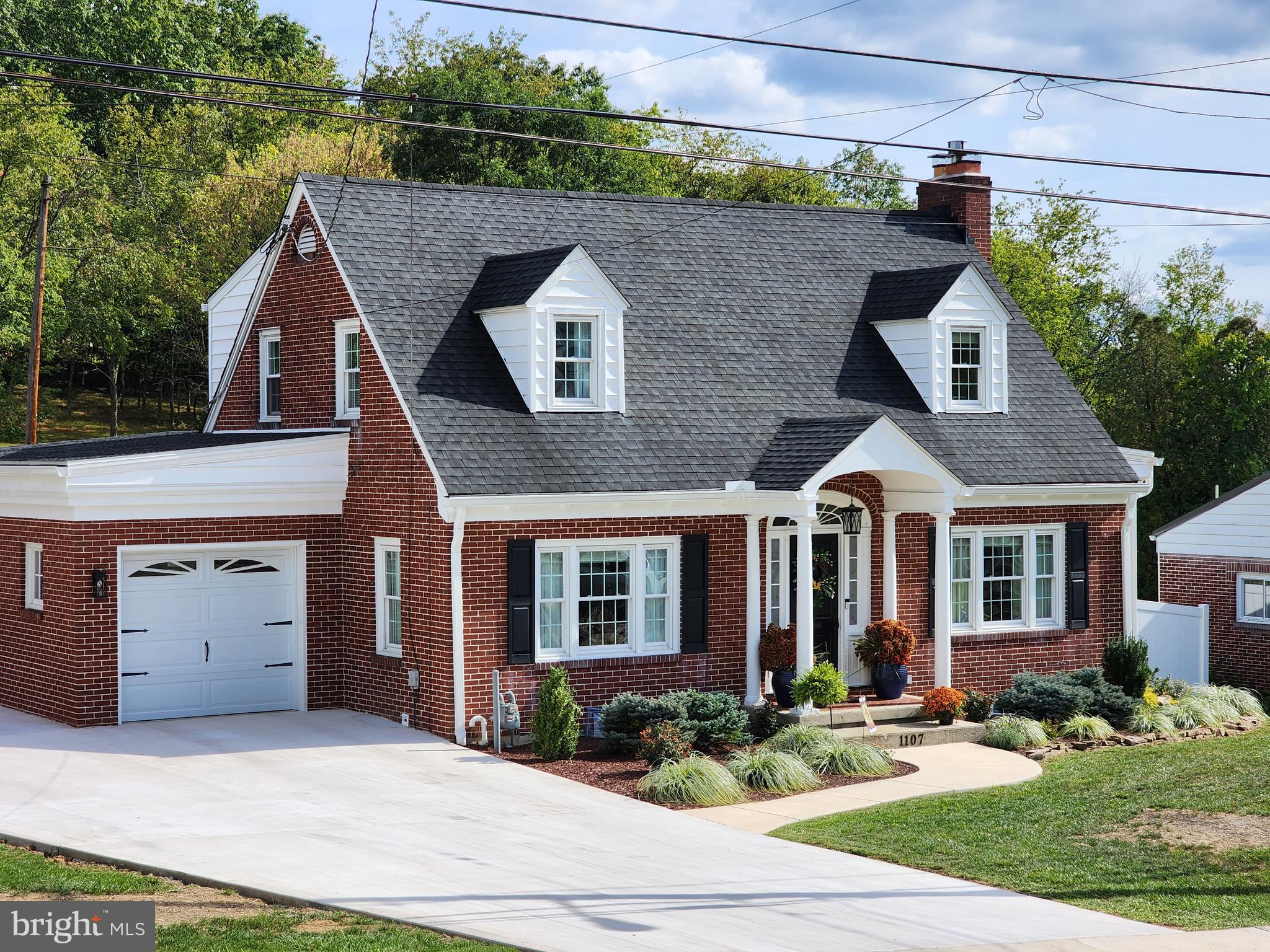 Discover this exquisite one-and-a-half-story brick home nestled in the North End of Historic Cumberland and Mountain Side Maryland. This rare find boasts 3 bedrooms, 3 and a half baths, with potential for an additional bedroom. Fully updated throughout, it features a main-level owner's suite tucked away at the rear for privacy, complete with a walk-in shower. Hardwood and tile floors adorn the spacious interior, complemented by a large kitchen with granite countertops and all appliances included. Enjoy meals in the separate dining area or relax in the sun porch with morning coffee. The living room, complete with a fireplace, and a separate gathering room on the lower level provide ample space for entertaining. Recent upgrades include a new oversized driveway, gas heat, central air, and an expansive private patio. Outdoor amenities include a "she shed," an additional equipment shed, and a fenced yard for privacy, along with a garage on a level lot. This home offers so much more than words can capture - schedule your visit today to see it all!