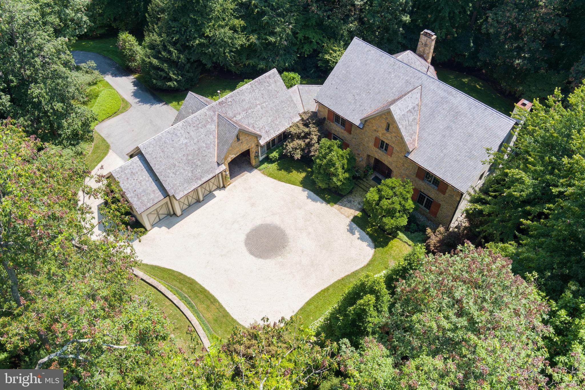 An estate drive leads through a barrel-vaulted archway to a beautiful motor court with surrounding gardens, water fountain and flagstone walkway to the main entrance of this stunning custom built 4 Bedroom luxury home. A 2-story Foyer with gracious oak staircase leads to a Study and incredible Living/Dining Room with oak architectural details, fireplace and built-in bookcases. The gourmet cherry Kitchen with granite and large sunny breakfast area flows to the Family Room with fireplace and beamed ceiling. A home office is adjacent the Kitchen. Main level Laundry Room and private 2-story Guest Suite with sitting room, bath and 2nd level bedroom. A sumptuous Primary Suite includes Primary Bedroom with fireplace, 2 custom fitted Dressing Rooms and spa Bath. Two additional en-suite Bedrooms, one with a large 3rd Level Loft, and Laundry Room are also found on the 2nd Level. The Lower Level features a Rec Room with wet bar, Media Room, Game Room with fireplace, full Bath and Bonus Room. Quarter-sawn oak floors on main level and 2nd floor Hall, custom built-ins, audio and lighting. Ipe hardwood Deck, stone Patio and Terrace, 3-car Garage. Professionally landscaped 3.75 acres in The Residences of Caves Valley Golf Club adjacent to the 12th green!